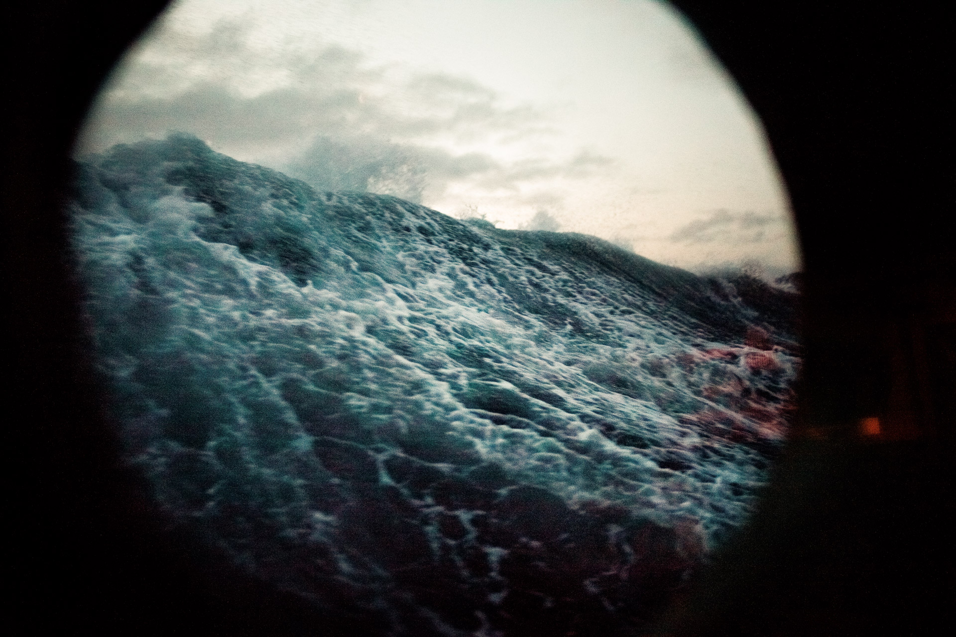 Stormy sea through a ship's porthole
