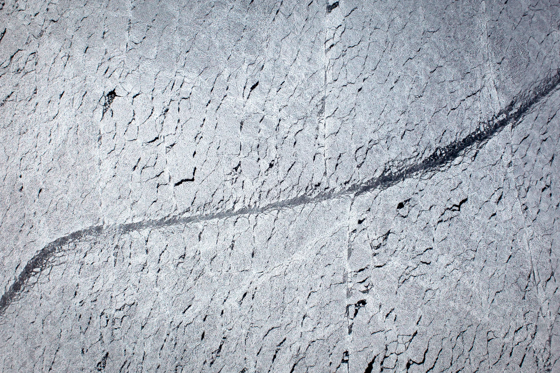 The track of a ship cutting through Arctic sea ice seen from the air