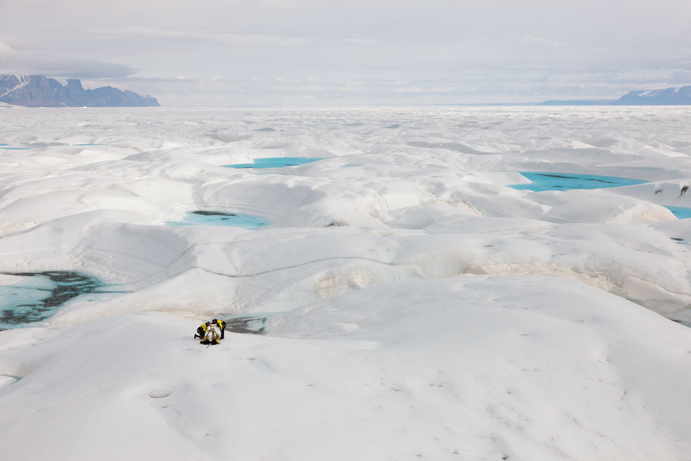 Scientists on the surface of a glacier on Greenland