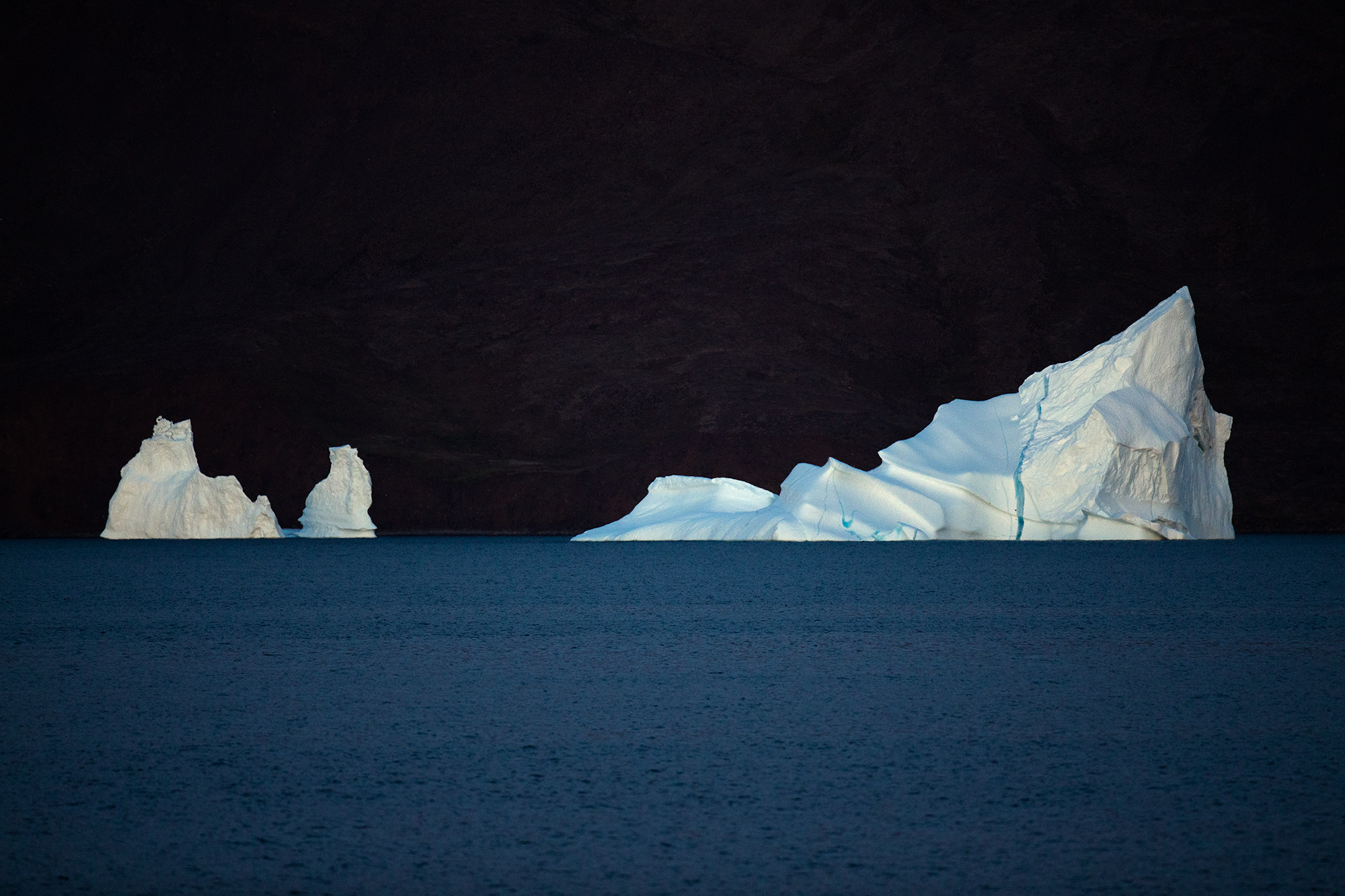 Iceberg lit by moonlight