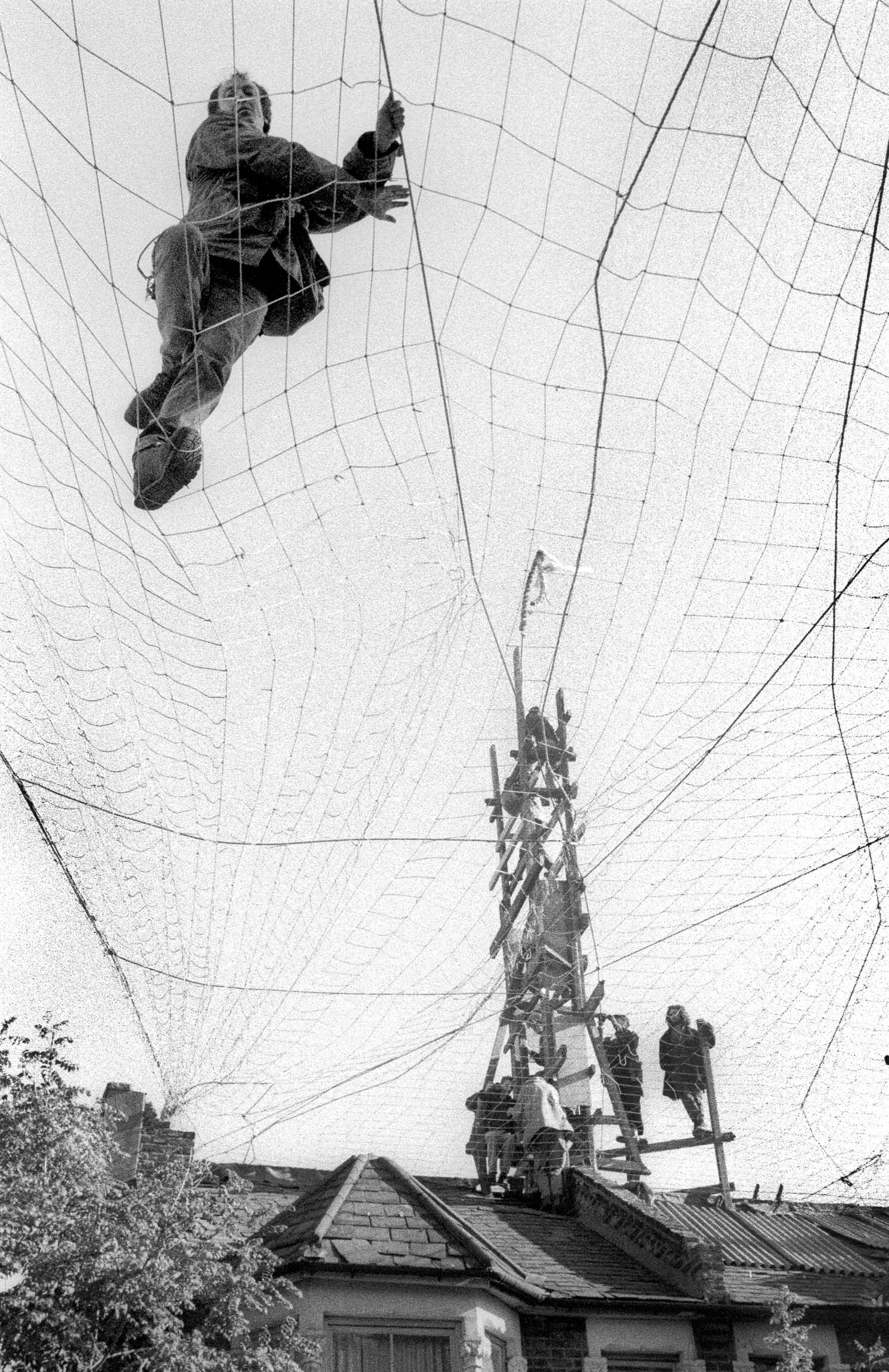 Protester on a net above Claremont Road