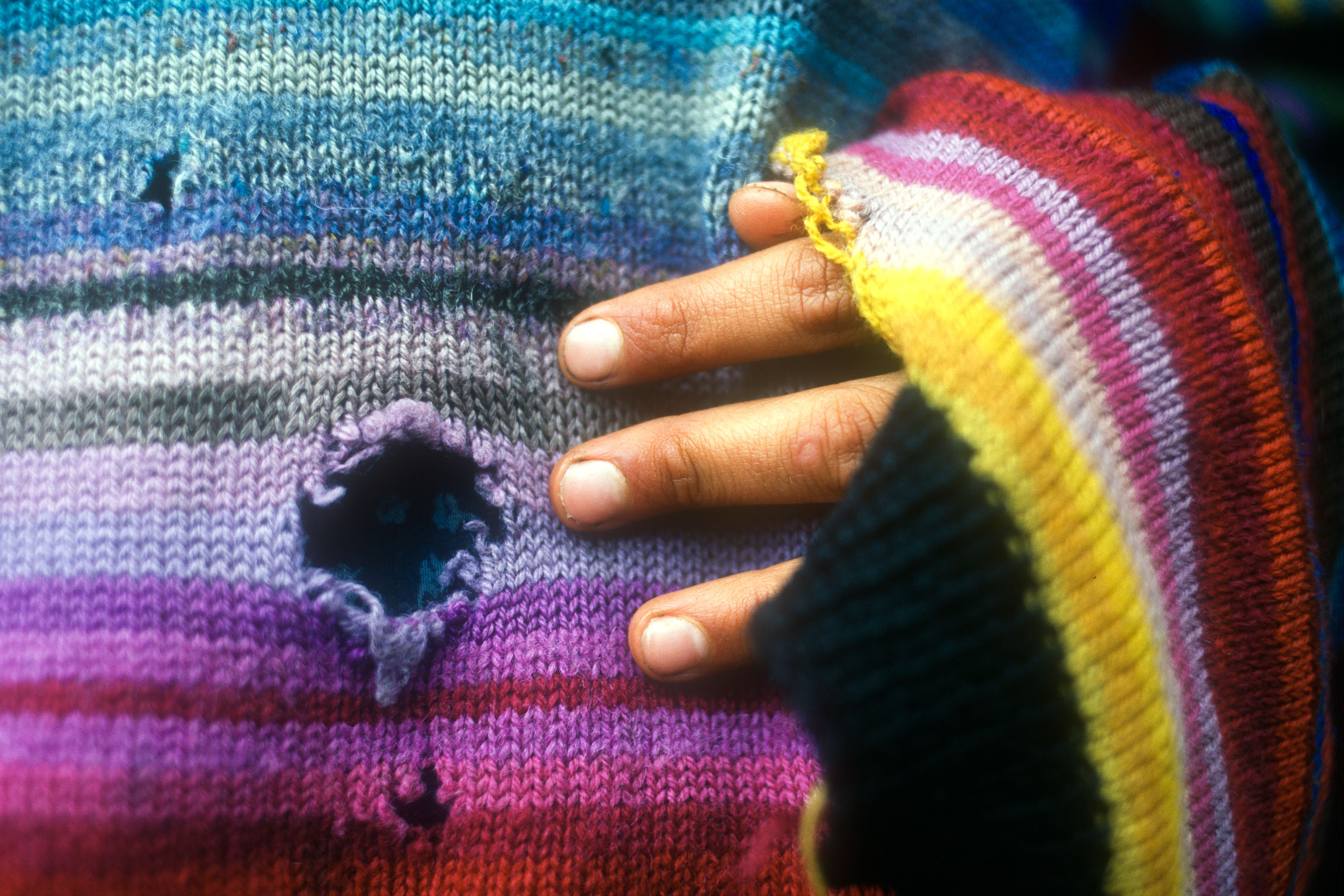 A hole in a protester's woollen sweater