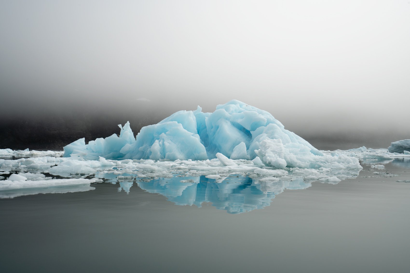 An iceberg reflected in ocean water