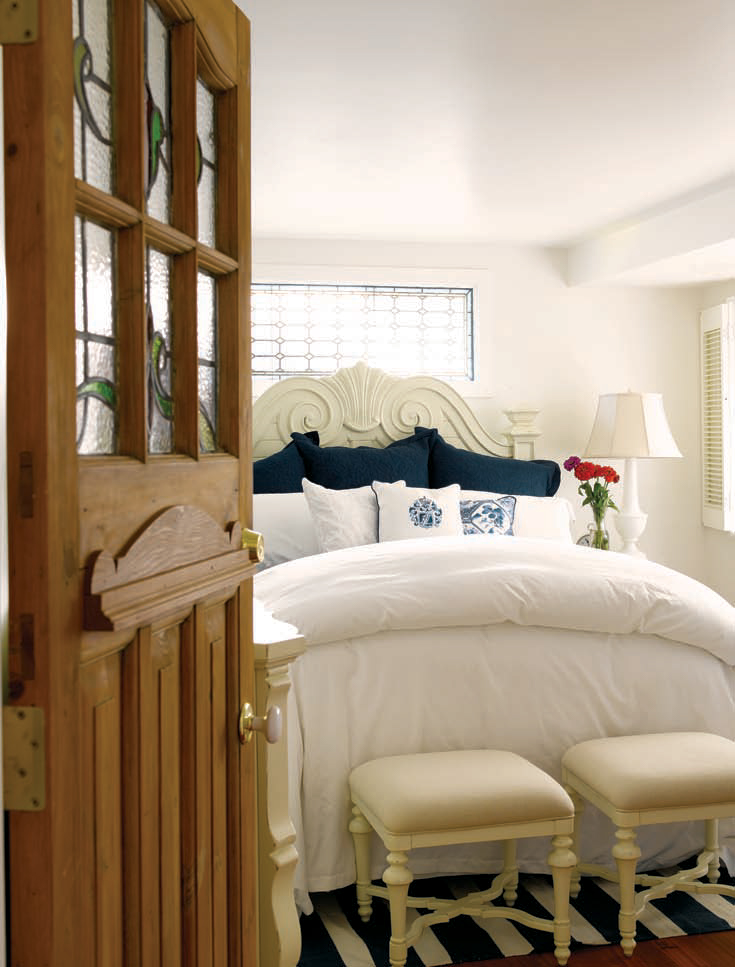 THE DOOR WITH A STAINED GLASS WINDOW THAT OPENS TO THE FIRST FLOOR MASTER BEDROOM WAS AN EXTERIOR DOOR IN THE ORIGINAL HOUSEBOAT.