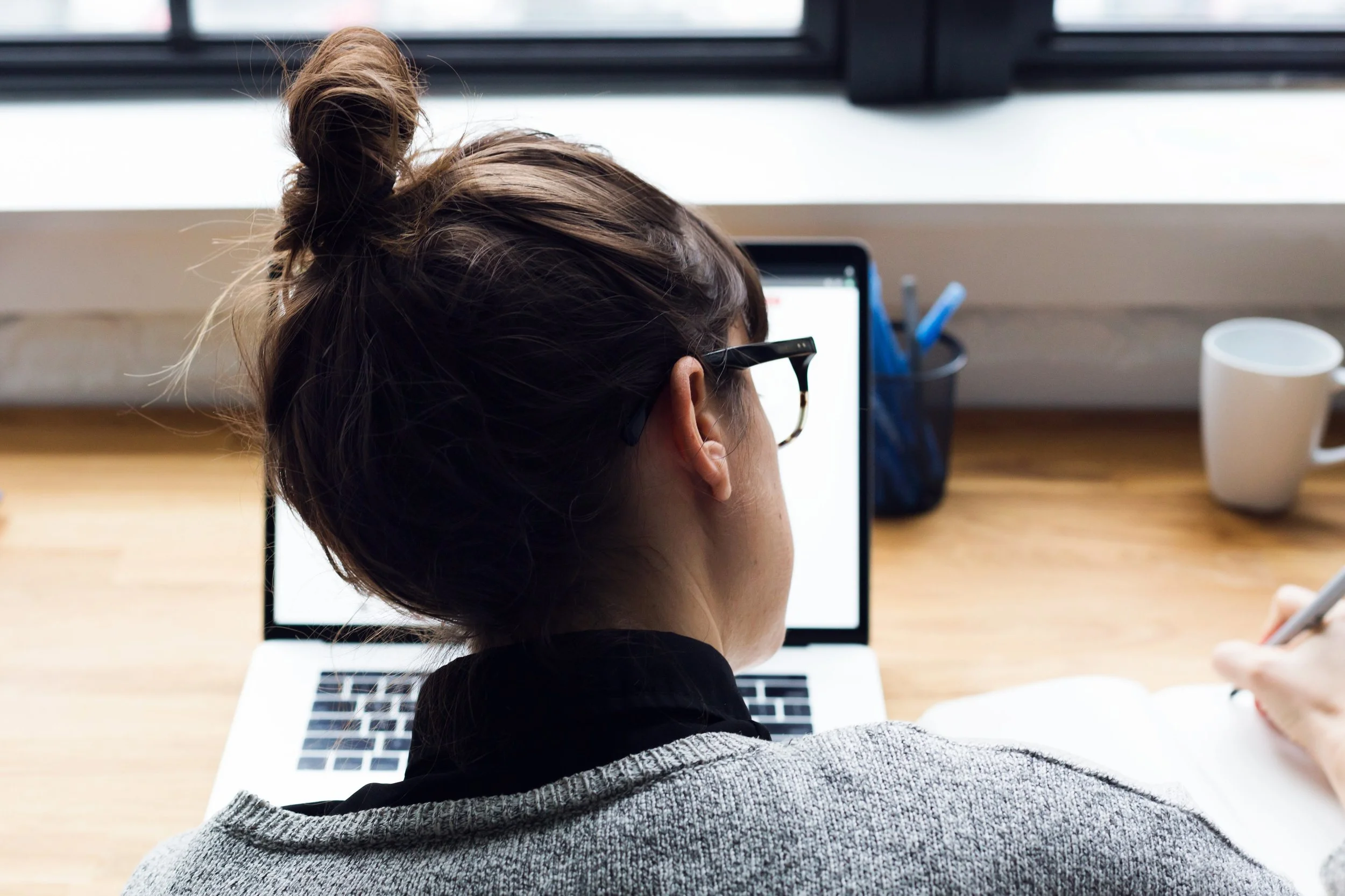 female-taking-notes-and-browsing-laptop_4460x4460.jpg