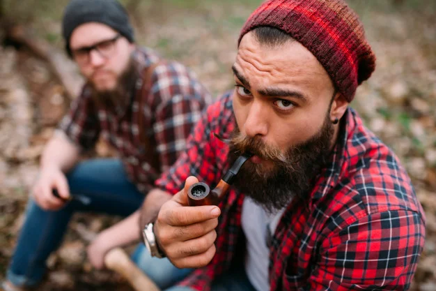 hipster-smoking-pipe-with-friend-in-woods_1429-2660.jpg