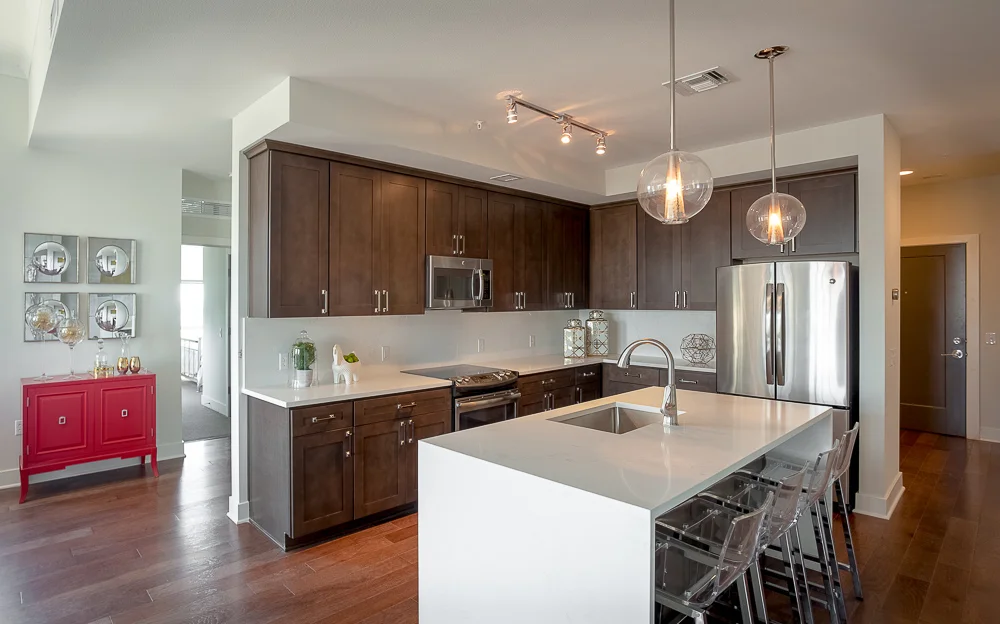 Amenities include wine lockers, a fitness facility, meditation chamber and wellness lounge, massage and red light therapy, valet dry cleaning and grocery delivery, housekeeping, concierge and room service, and personal training.