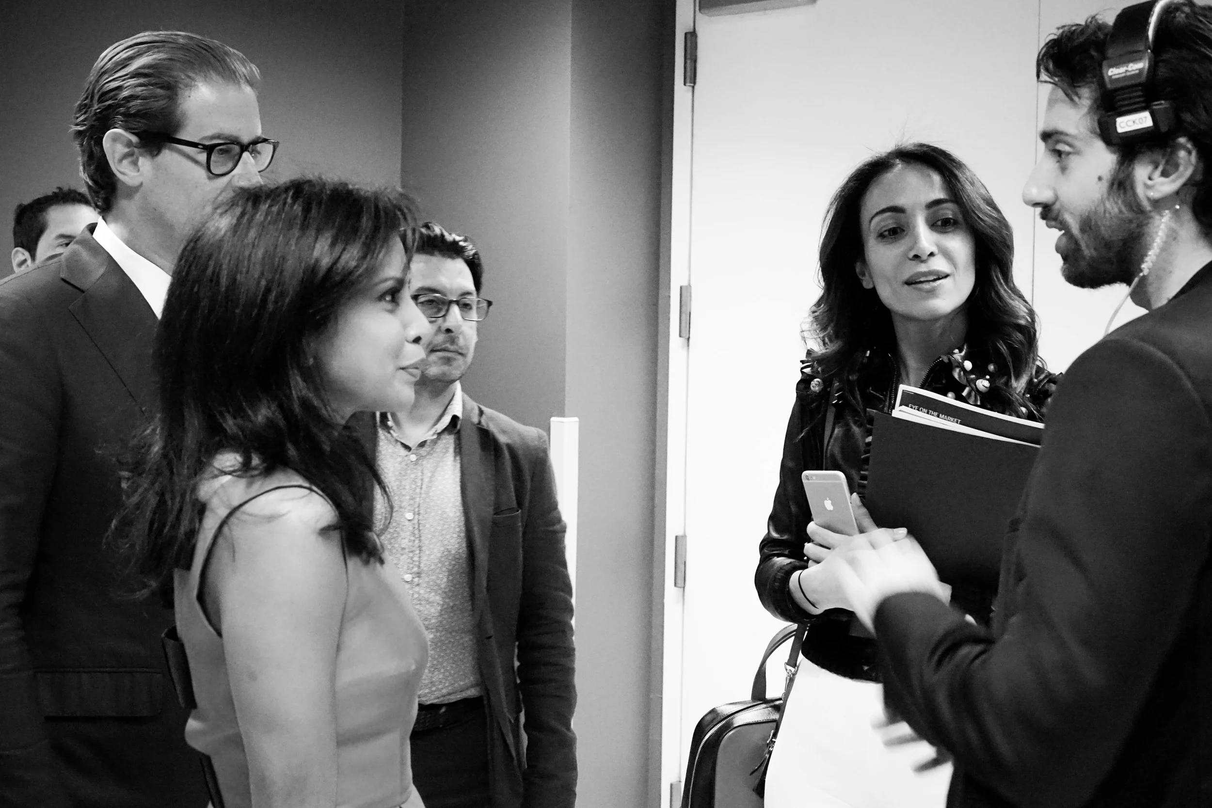 Hitha Herzog at the Fashion Culture Design Conference, receiving stage direction in a group.