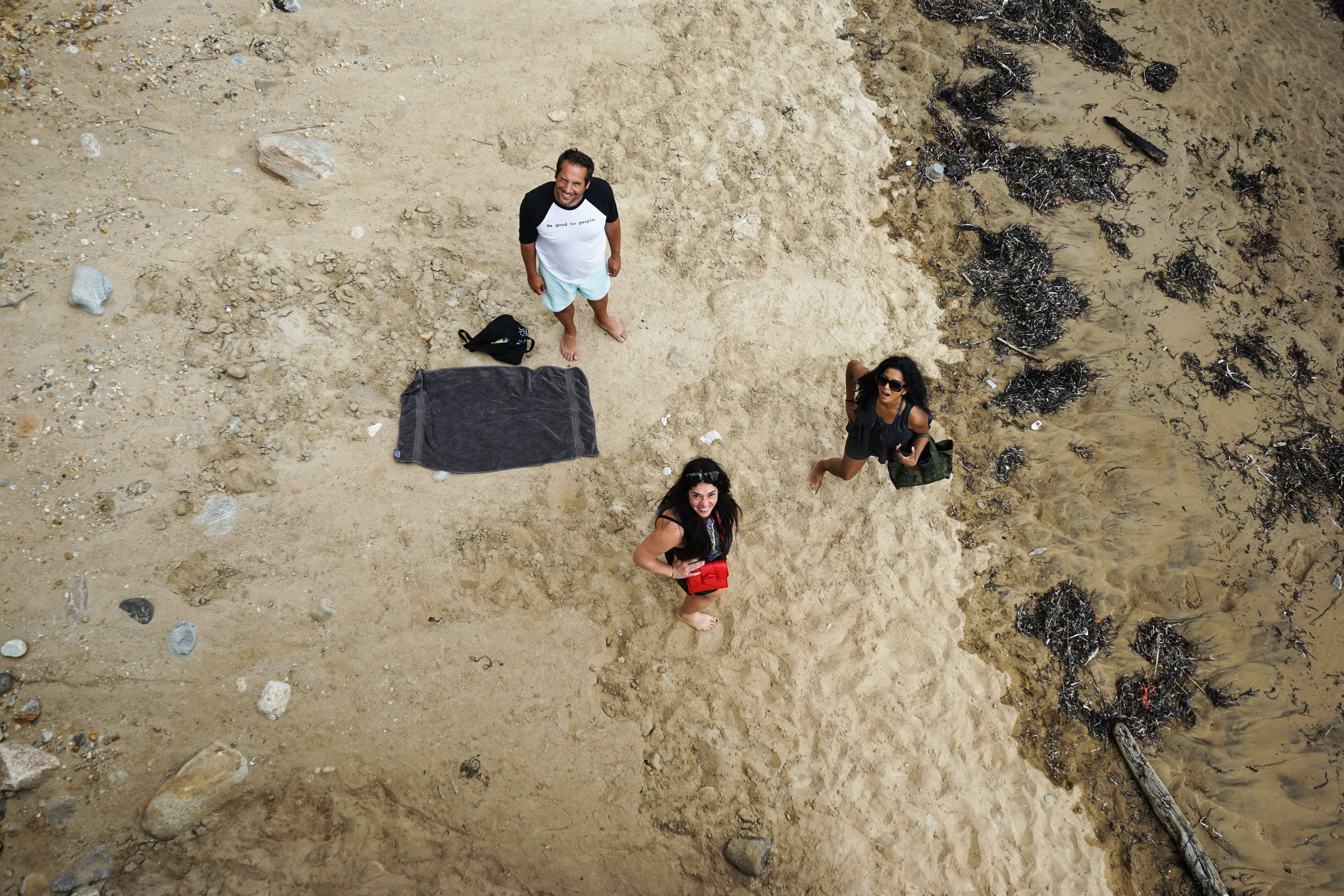 Aerial shot of Hitha Herzog, her husband Seth, and a friend on the beach below.