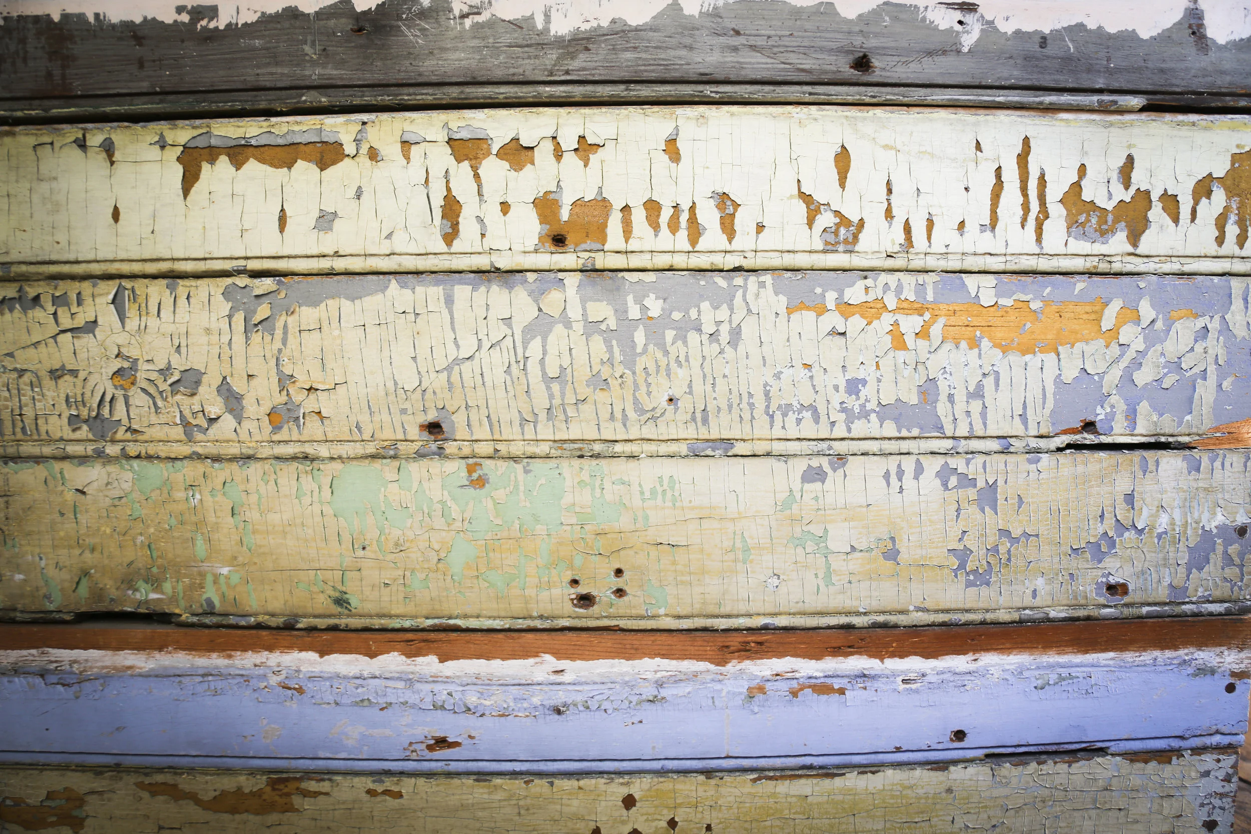 In the barn attached to the house you can see a spot on the stairs where the layers of paint show the different shades of color that the house was at different points in time.