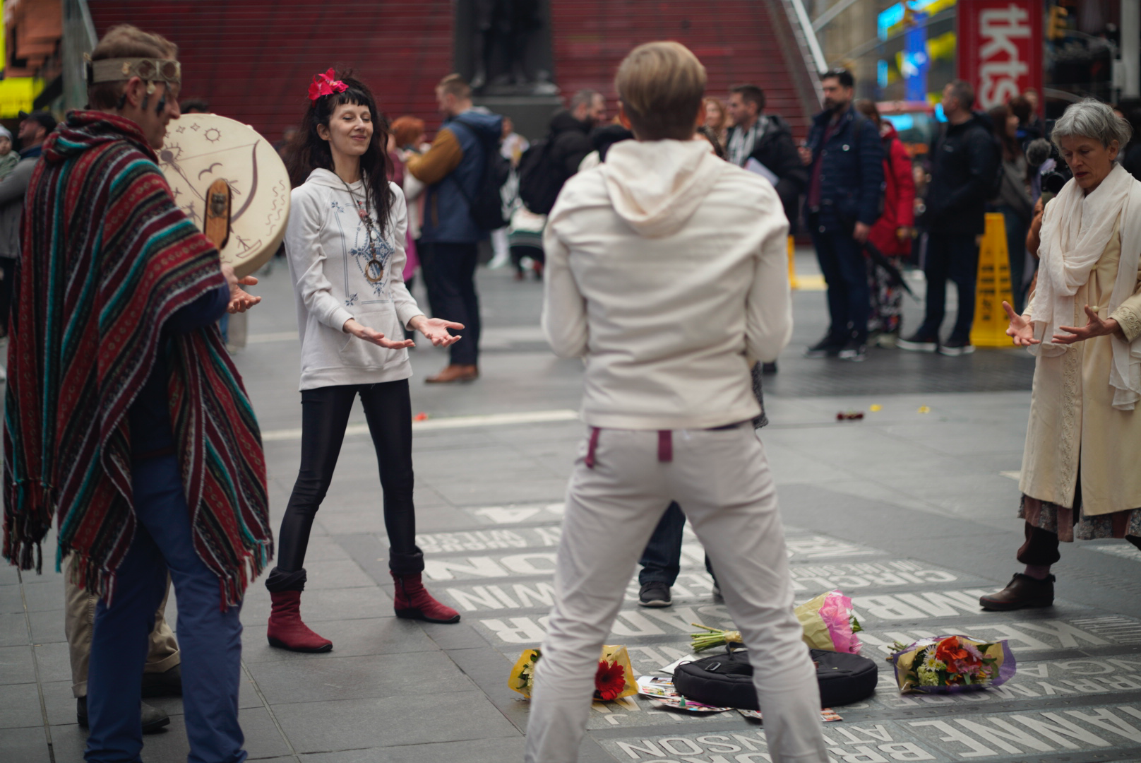 Vangeline and Participants in Times Square in a peace circle April 6, 2025 at Flower of Life Marathon.