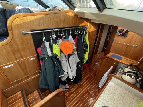 Rack for hanging wet weather gear makes it easy to find at night