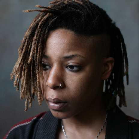 Jonquille Rice aka Solsis was born on August 4th and has been a Washingtonian ever since. Her love of music and expression stems deep to her childhood days of Casio keyboard compositions and singing in the church choir. A graduate of Bowie State University, Solsis is the host of Washington D.C.’s only Queer Women of Color open mic, Lyrics & Lace (L&L). She is also the lead vocalist of all-girl Rock & Soul band, The CooLots, and as a poet in her own right, she’s performed with organizations like Human Rights Campaign, WOW Theatre Cafe’s Rivers of Honey, and Baltimore’s Hexagon Space. Her influences include Nikki Giovanni and Me’Shell N’Degeocello while her own infectious energy has been compared to the likes of Hanifah Walidah. An emerging community icon, Jonquille has also modeled for masculine of center women of color collective, bklyn boihood, as their December 2012 Calendar Boi. Continuously bridging the gap between artists and audience, and giving voice to the marginalized through her own creative spirit.