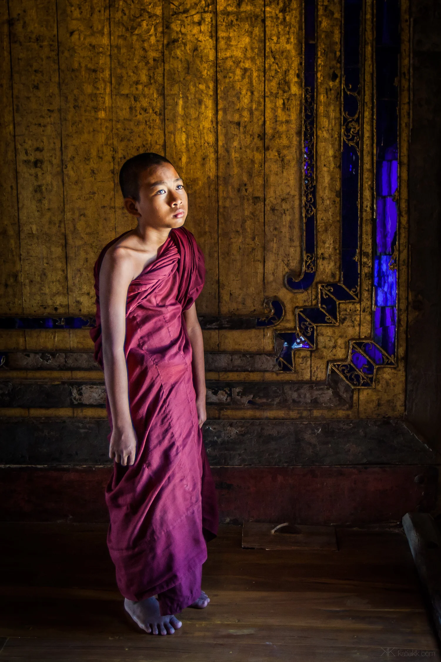 Myanmar, October 2014 Discovering an old monastery on the way to Inle Lake. I saw the golden sheen of the walls with blue pieces of glass used as a decoration. The light was beautiful and there was this young monk with a sorry face. I guess Monday arrived earlier than expected. 