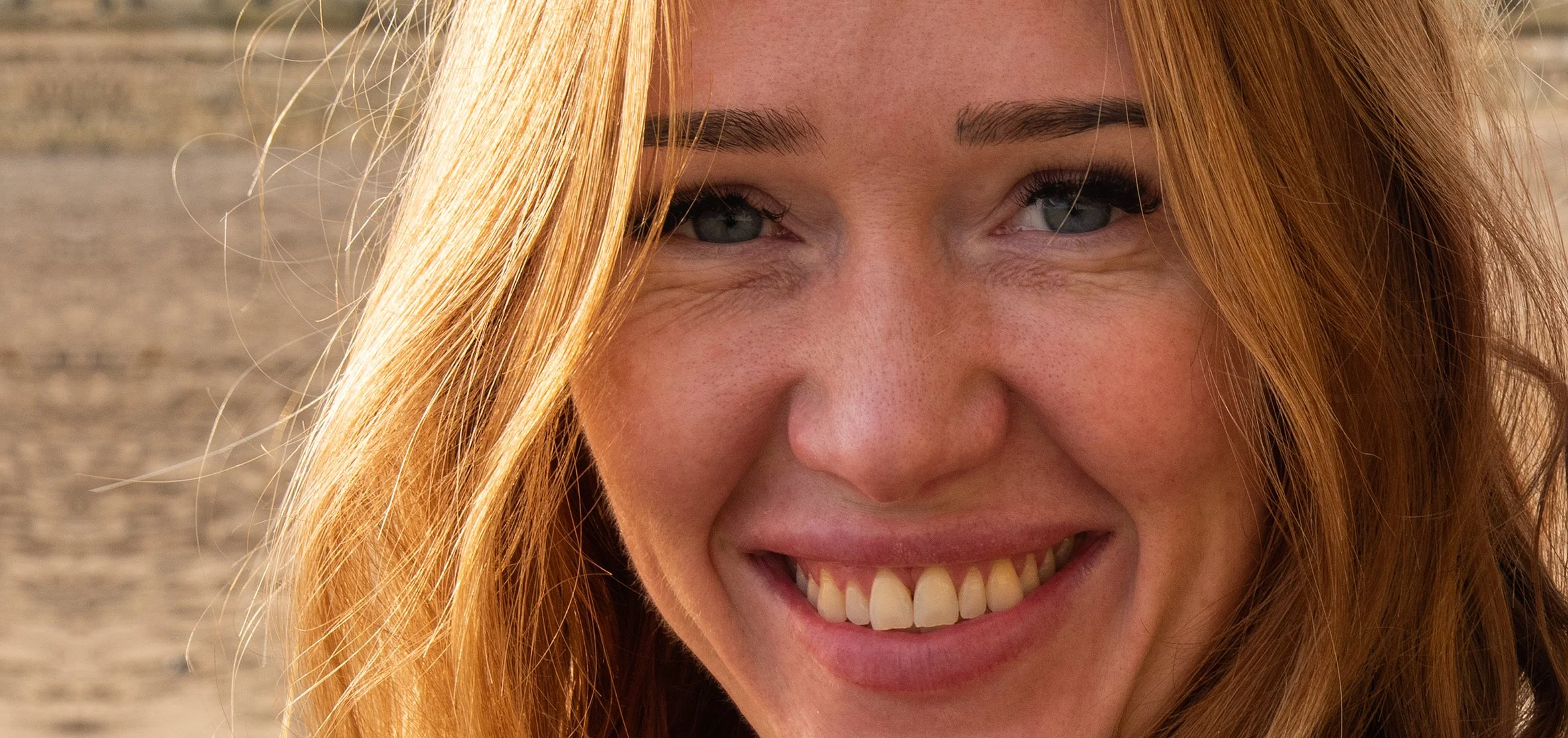 9799redheadsmilingonthebeachIYFpan30.jpg