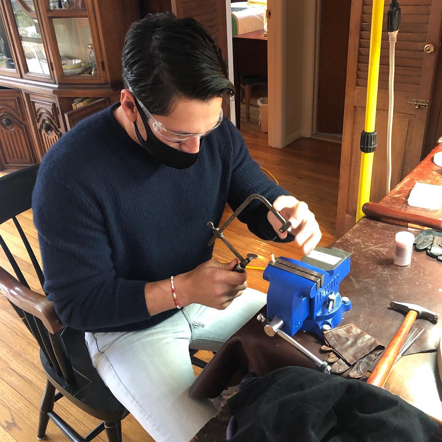 Student sawing tiny 22 karat gold part epoxied onto a dowel for ease and control. #tinygoldparts #tinygold #smalljewelry #22karatgold #workshops #gold #oneofakindjewelry #22karatgoldjewelry #22karatgoldjewellry