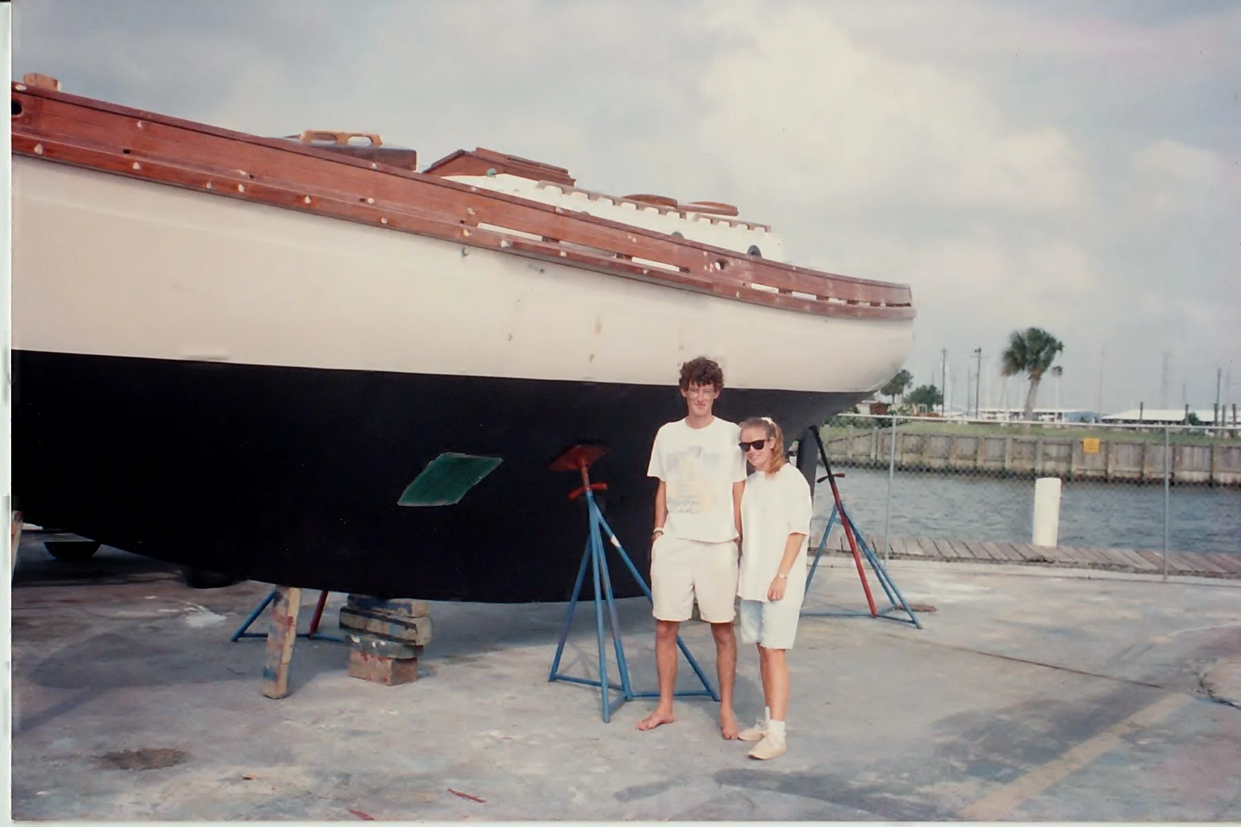 Tretorns, bare feet. I think he still has those shorts.