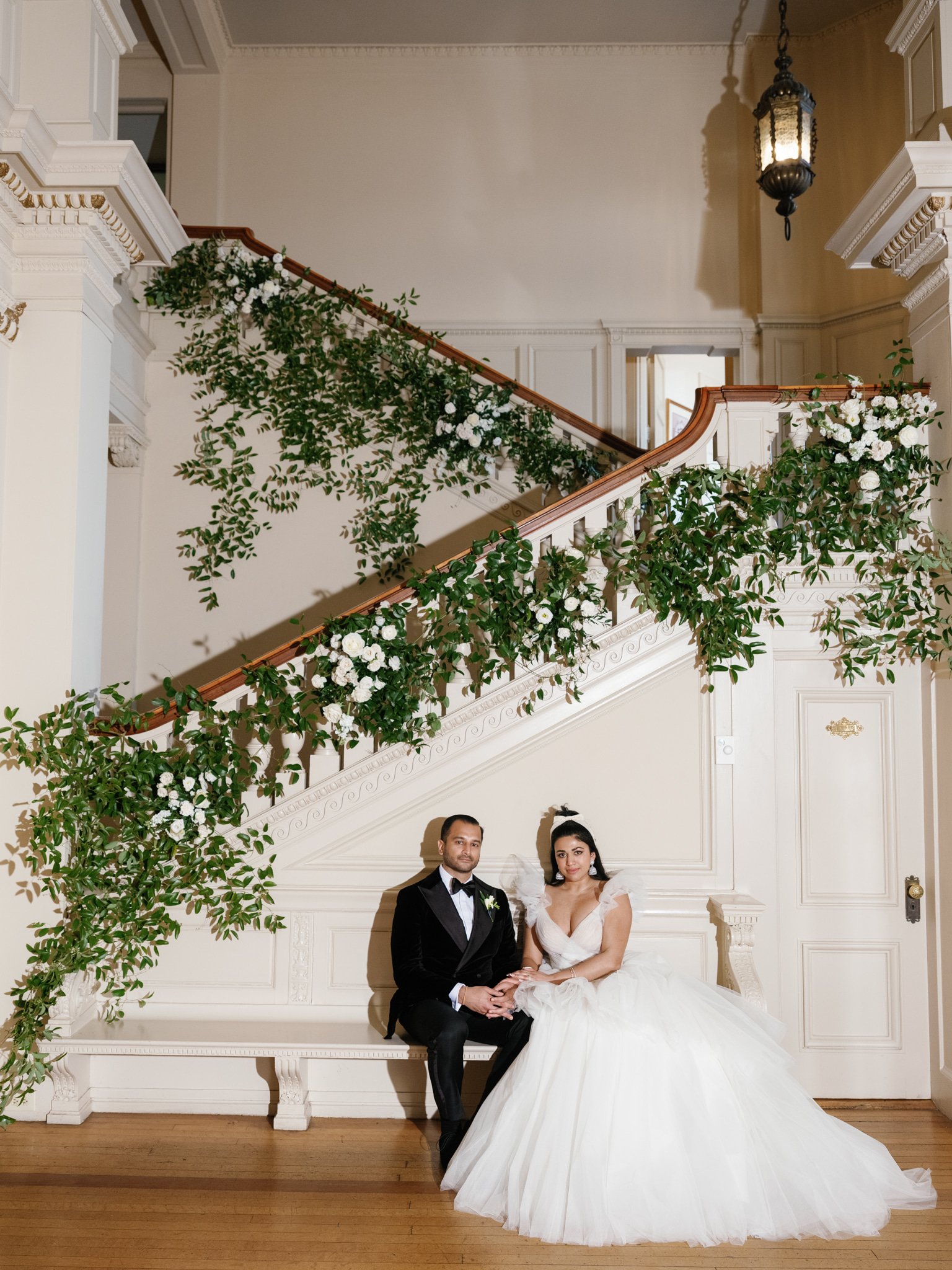 wedding-couple-cairnwood-staircase-greenery.jpg
