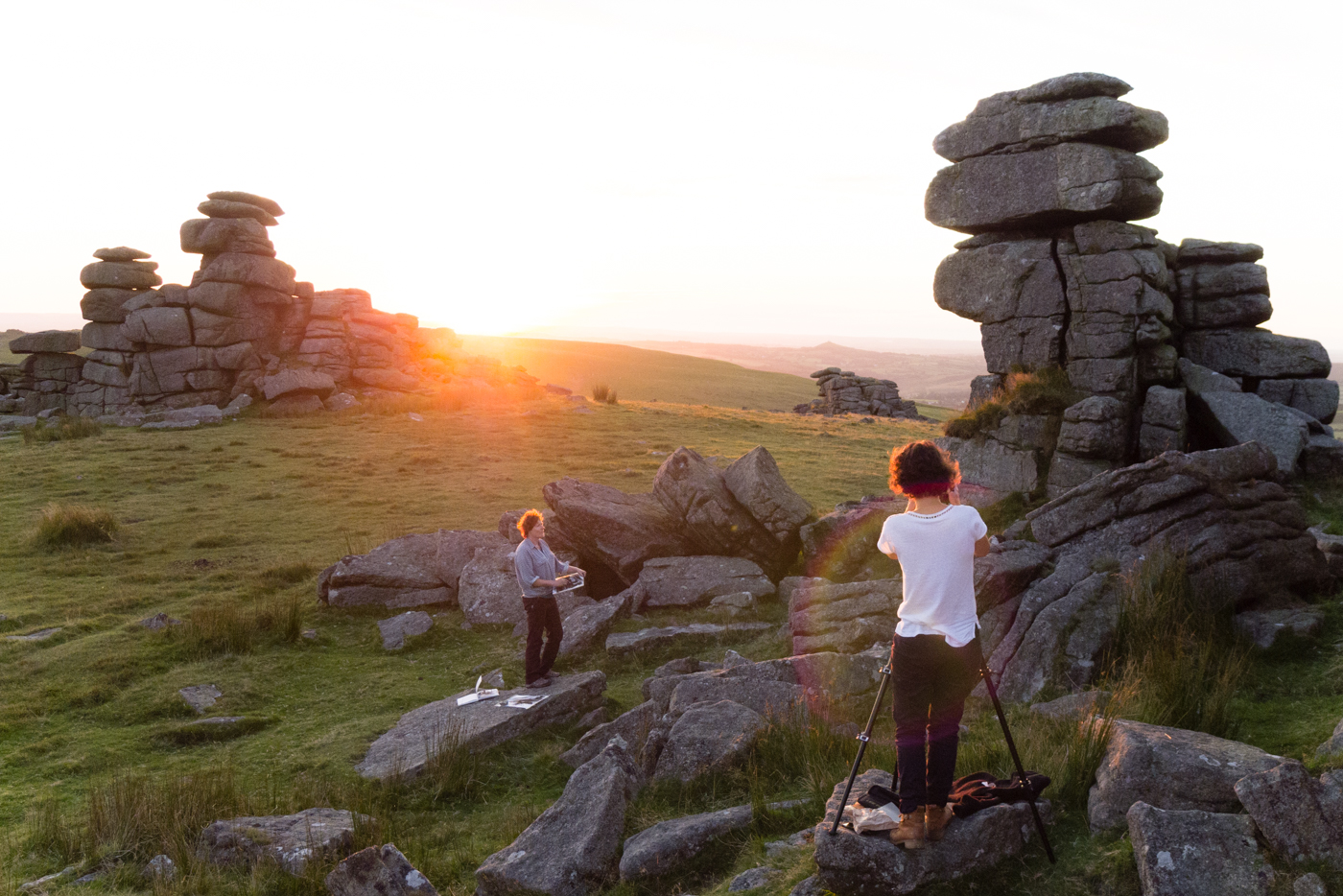 Suzy Bennett photographs Dartmoor printmaker Anita Reynolds sketching at Great Staple Tor. 