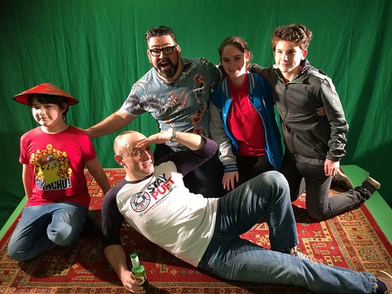 Richard Elis (Chief of Police, Hanky Panky and Genie, Dai The Lamp) and Liam Tobin (Widow Twankey) prepare to take a ride on a magic carpet with the children at the press evening for Aladdin at Newport Riverfront.
