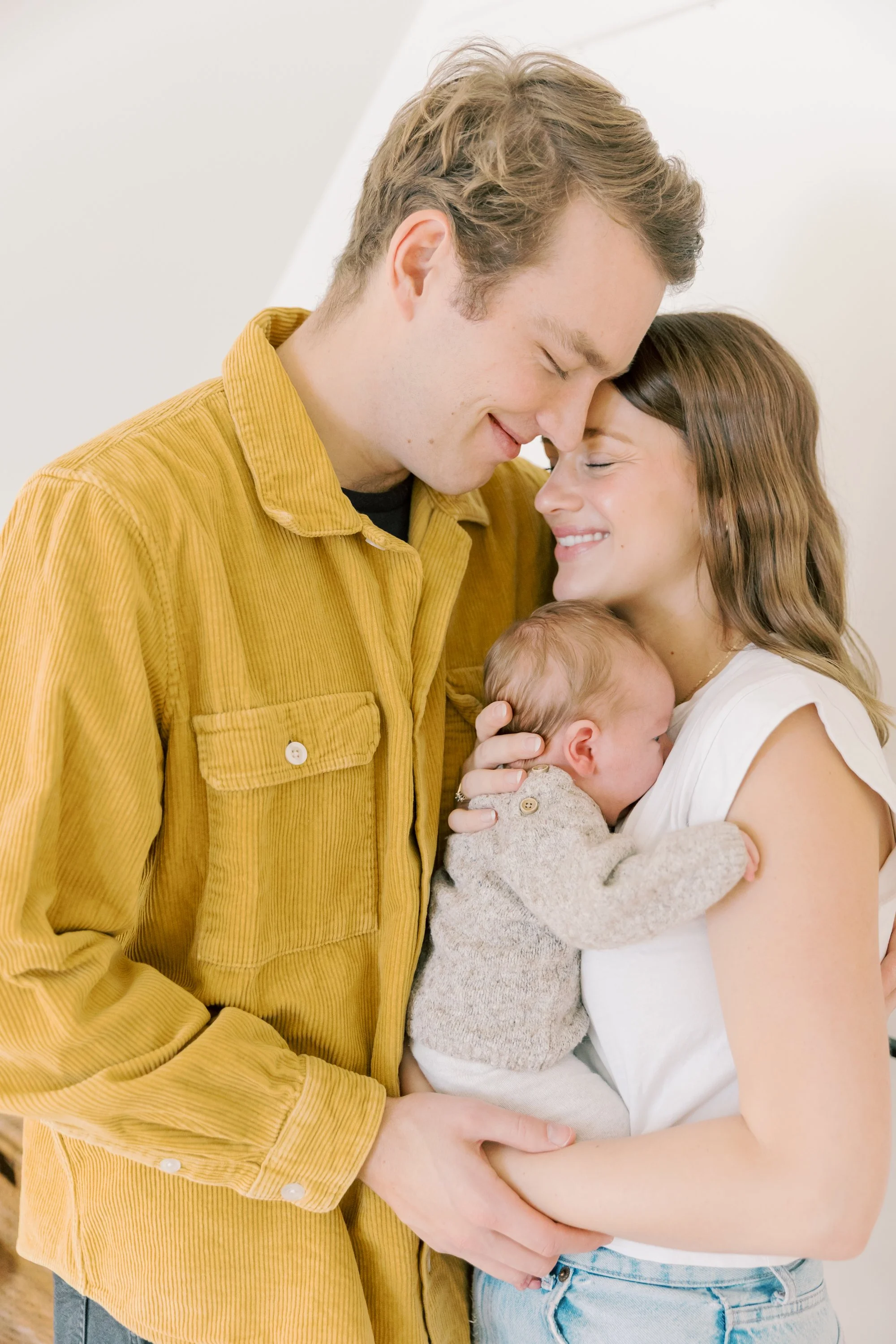 Mom, dad and newborn baby during an Oakville Newborn Photography session in their home