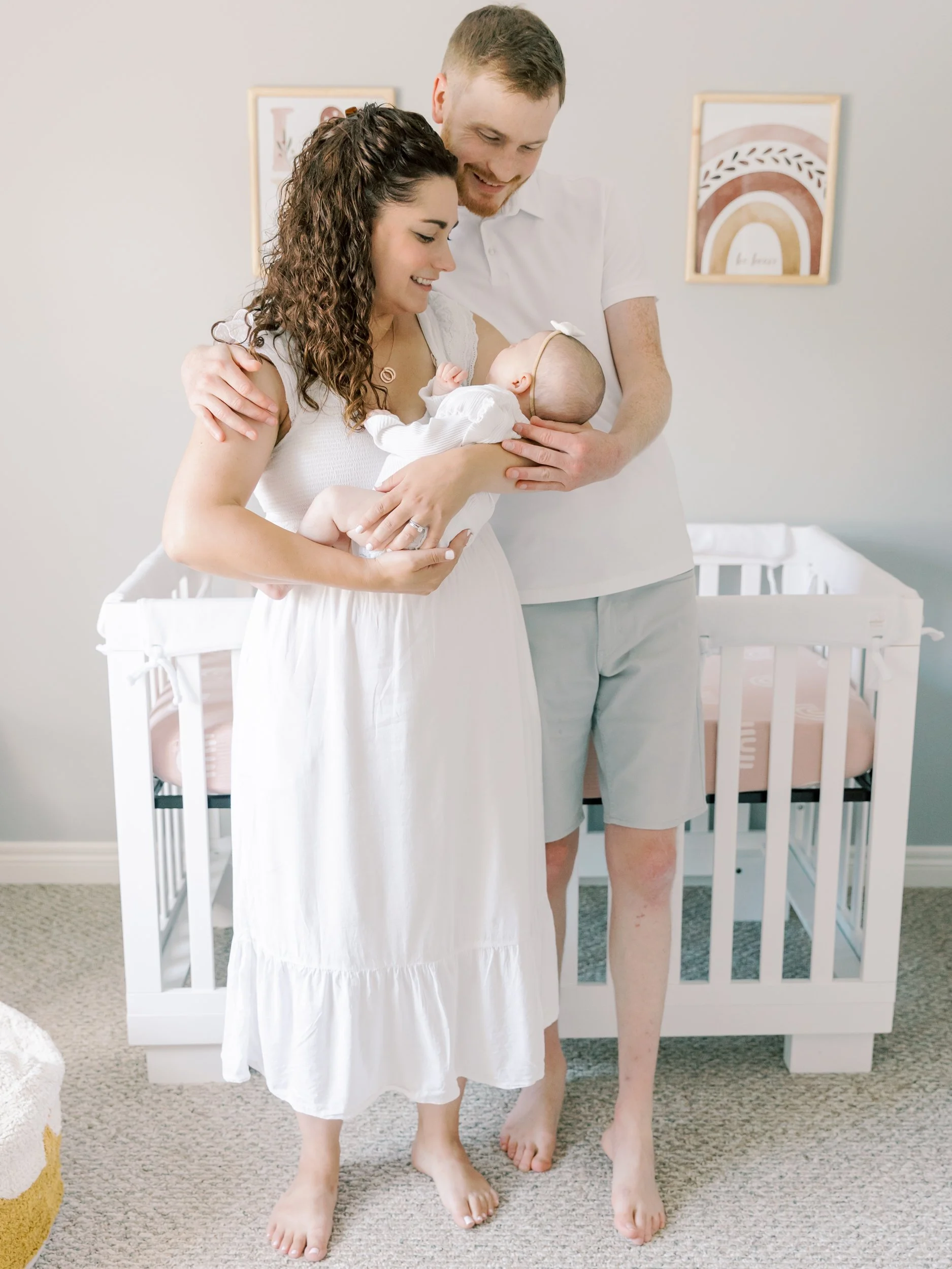 A natural, unposed moment between parents and their baby during an in-home session with a lifestyle newborn photographer in Oakville.