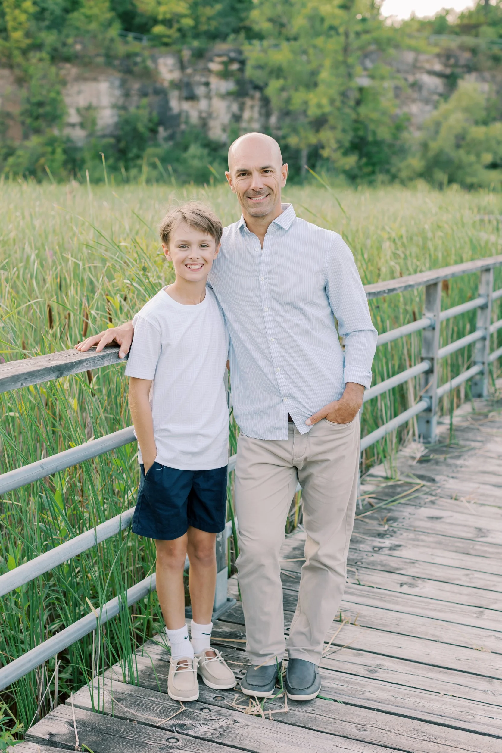 A family walking along the boardwalk during a lifestyle session at Kerncliff Park in Burlington, Ontario.