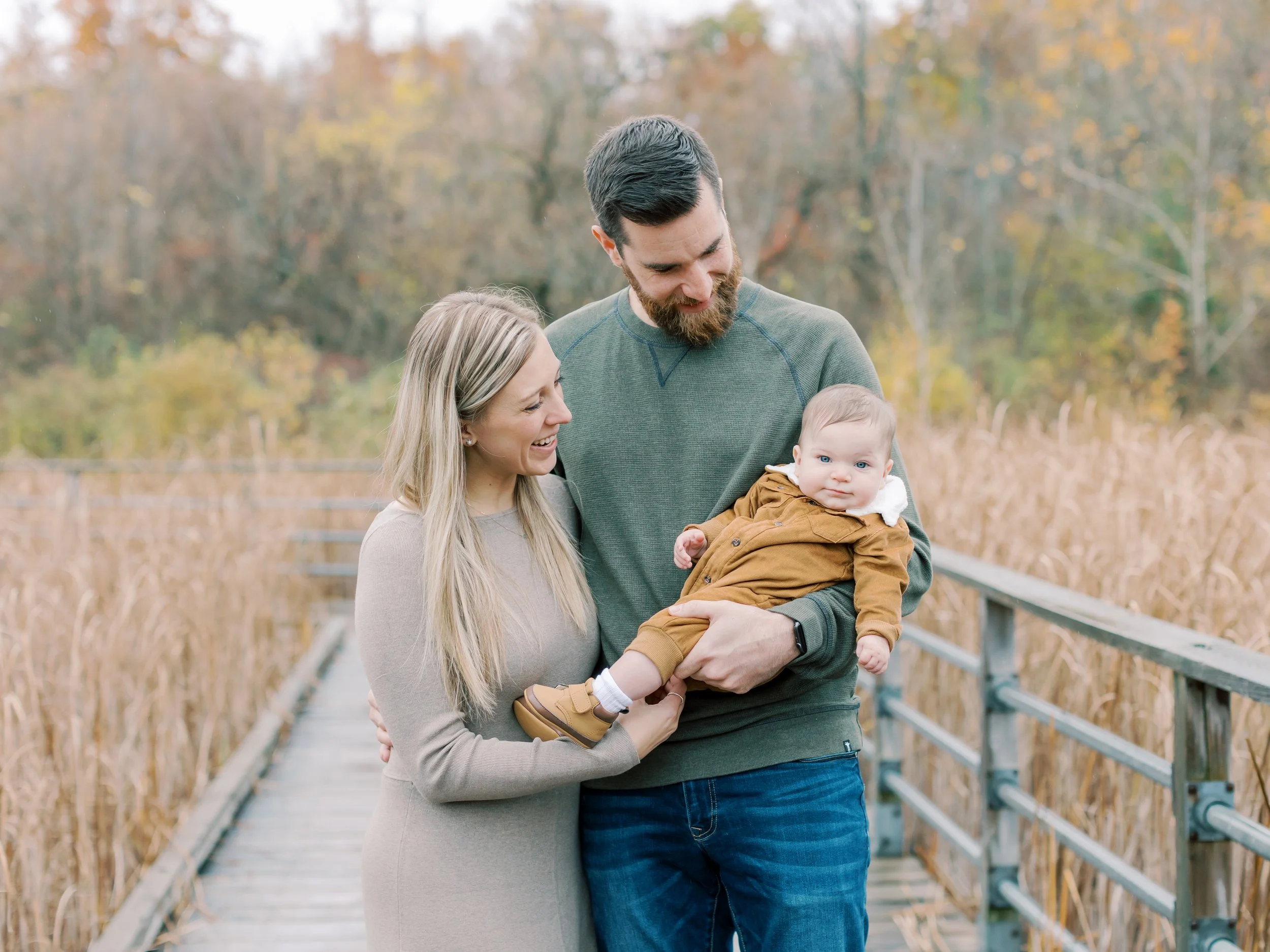 rainy fall family photos in Burlington mom dad and baby boy