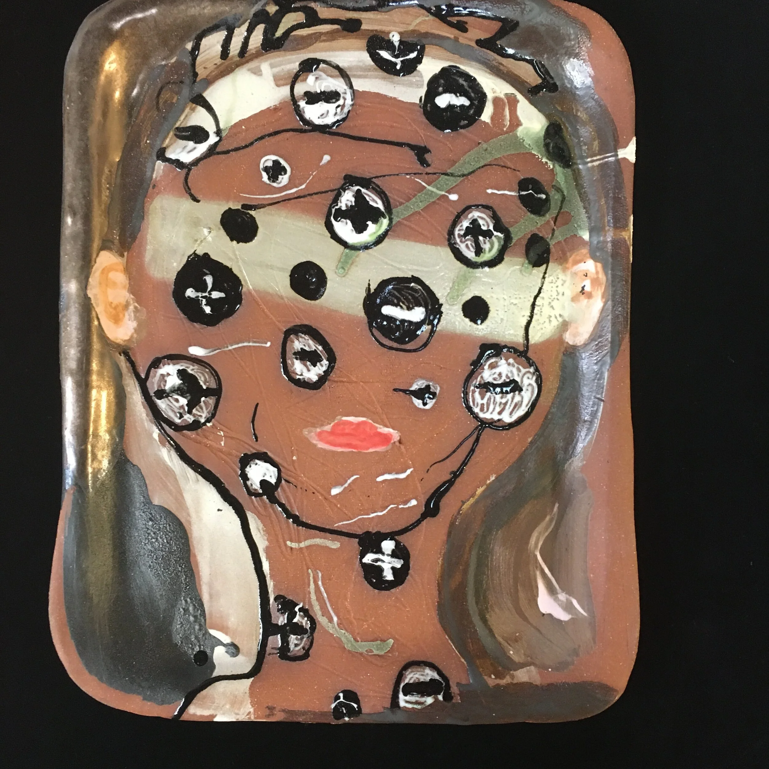 Charged head red clay draped from school lunch tray glaze/underglaze  9 by 12 inches 2020