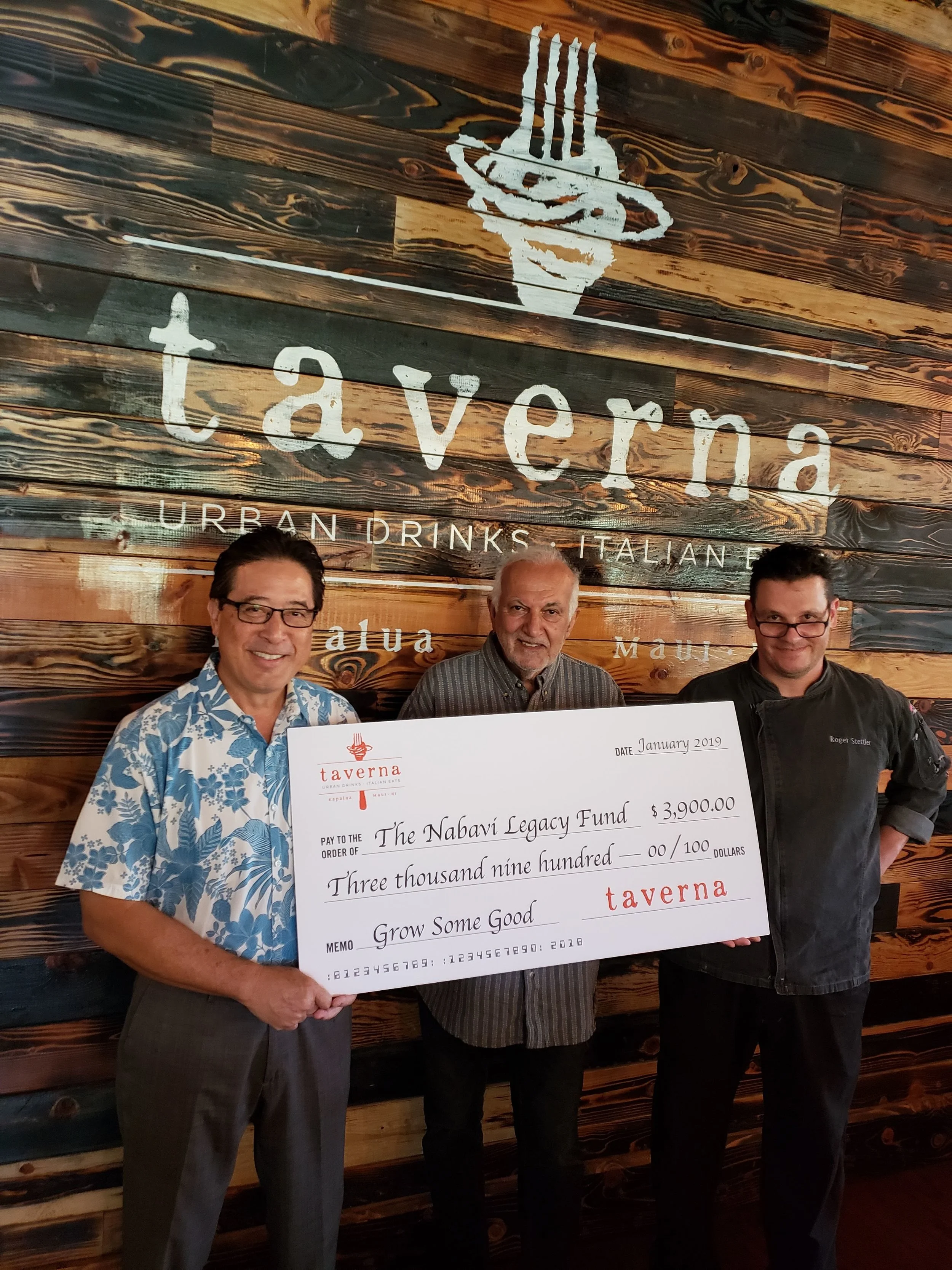 Taverna principal partner Chris Kaiwi, Nabavi Legacy Fund founder Paris Nabavi and Taverna executive chef Roger Stettler with the donation check.