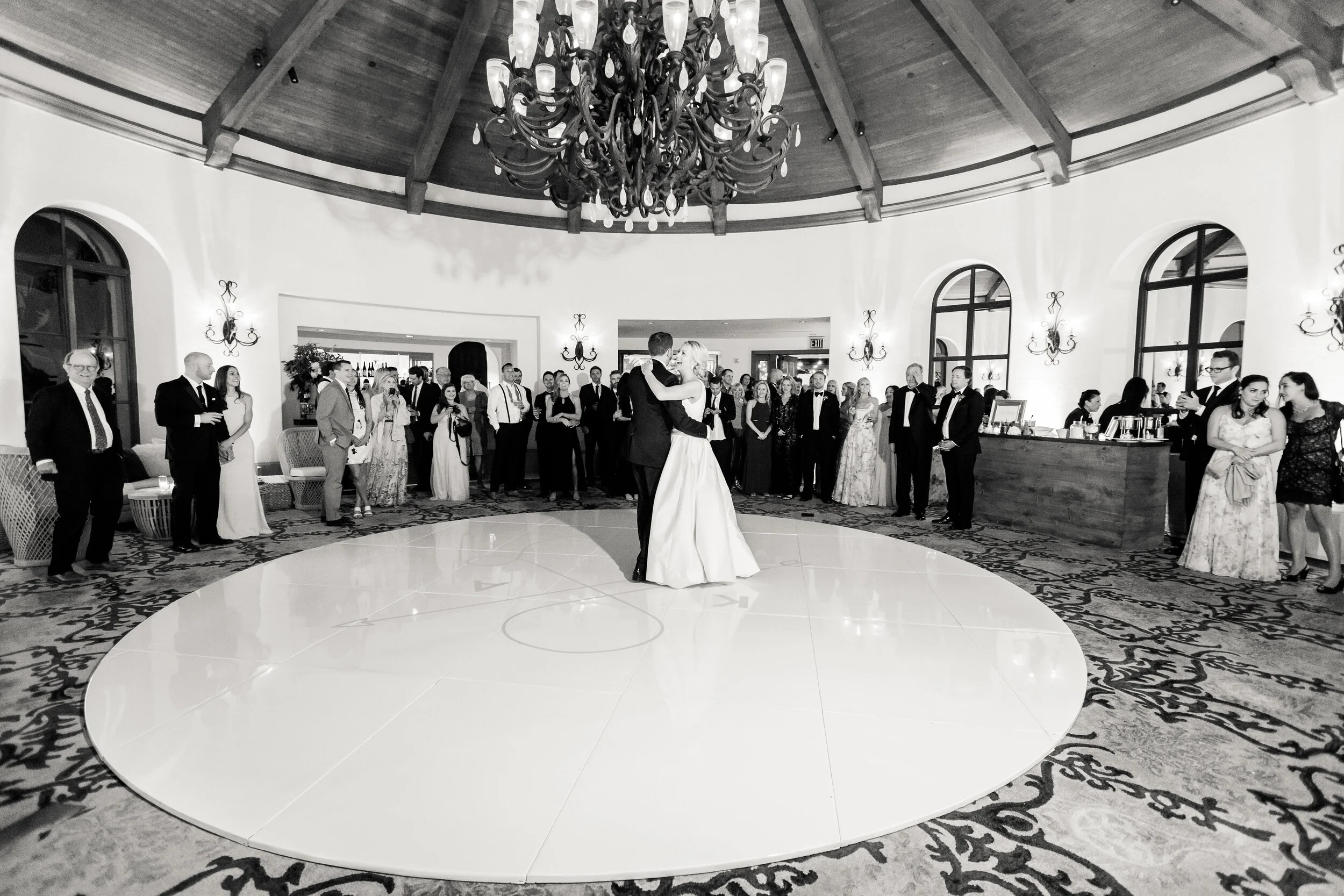 First dance as husband and wife on a custom seamless round dance floor with their logo in blush pink