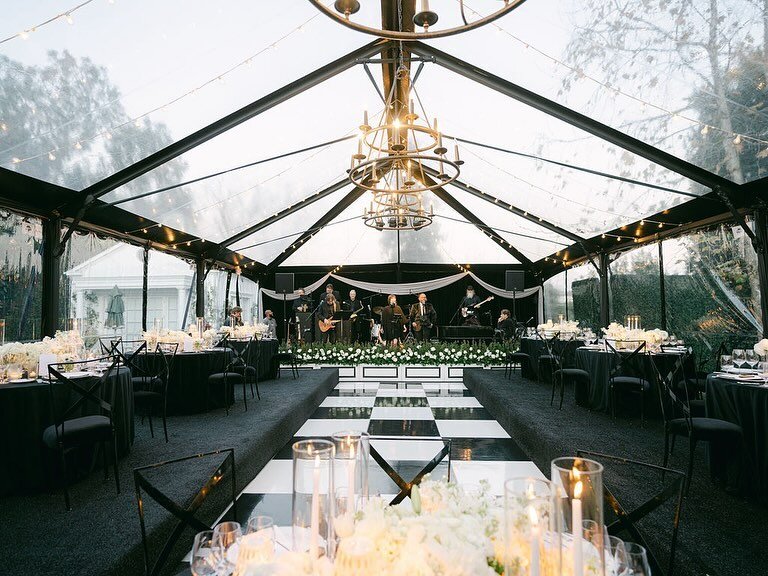 This tent was designed to keep guests warm during a chilly spell in California. We wanted to create a space that felt similar to an old school steak house with different levels of seating. The tones were kept dark- rich black velvet, deep red roses a