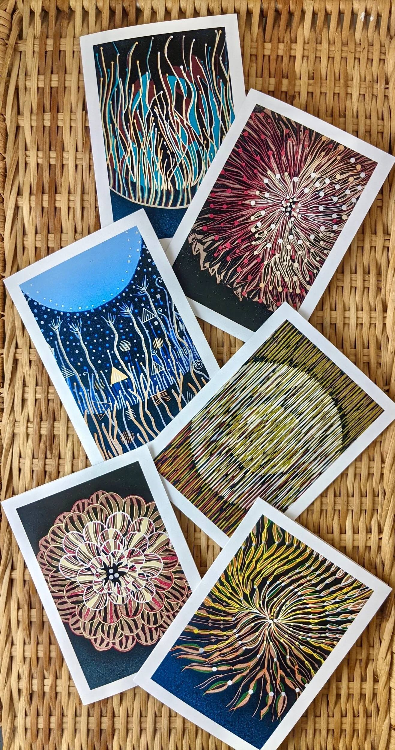 set of six greeting cards reproduced from the Small Whispers Series. Printed on archival linen card stock and arranged on a wicker background.