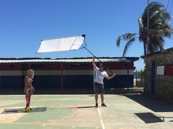 An assistant hold a skrimm above Rose Bertram Janine Berey