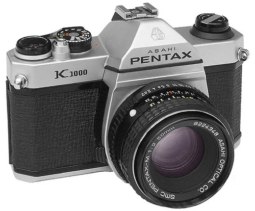 The Pentax K1000 is an interchangeable lens, 35 mm film, single-lens reflex (SLR) camera. The K1000's sturdiness and longevity make it a camera legend.