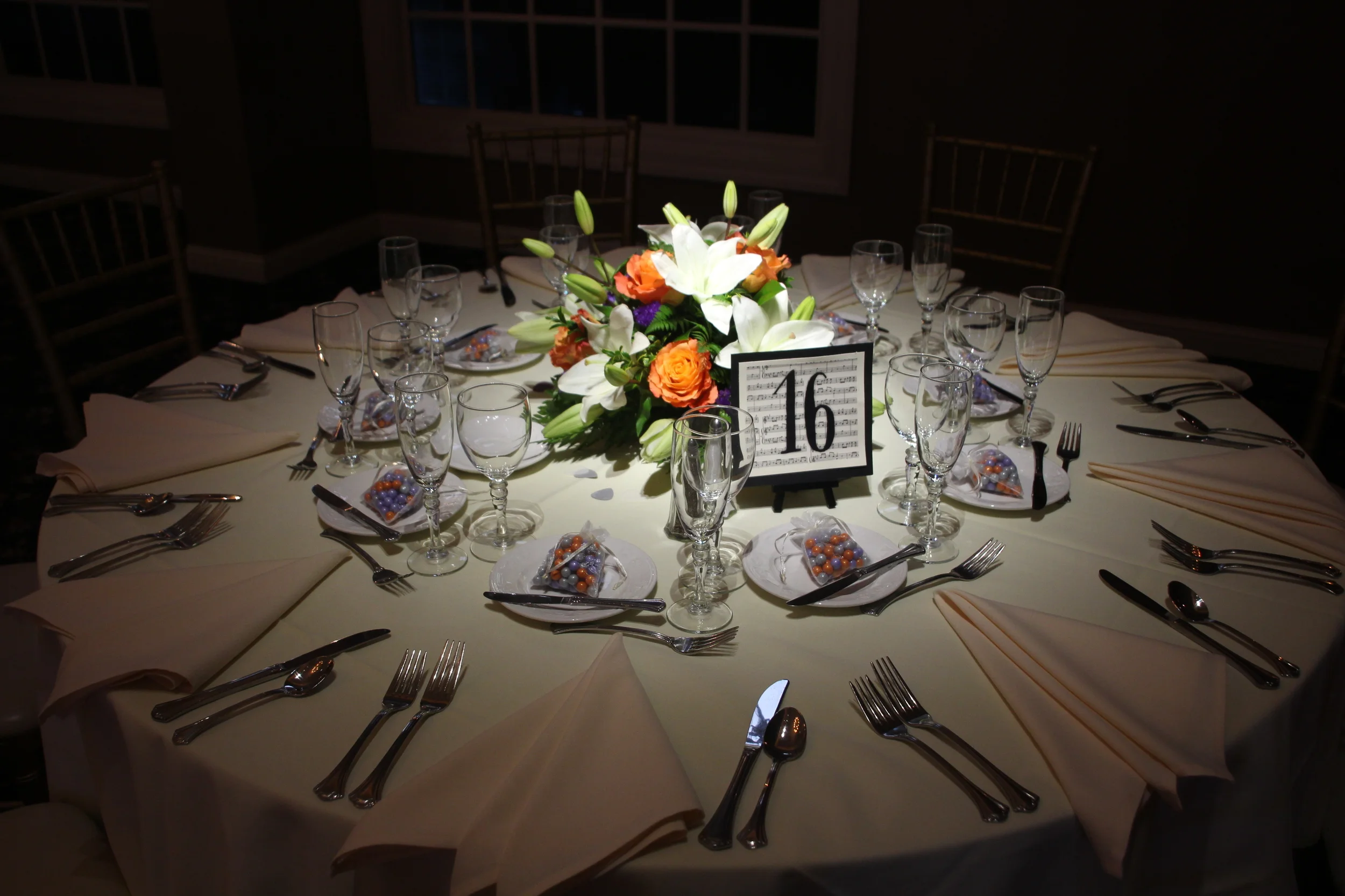 Beautiful floral centerpieces by House of Fabian on half of the tables.