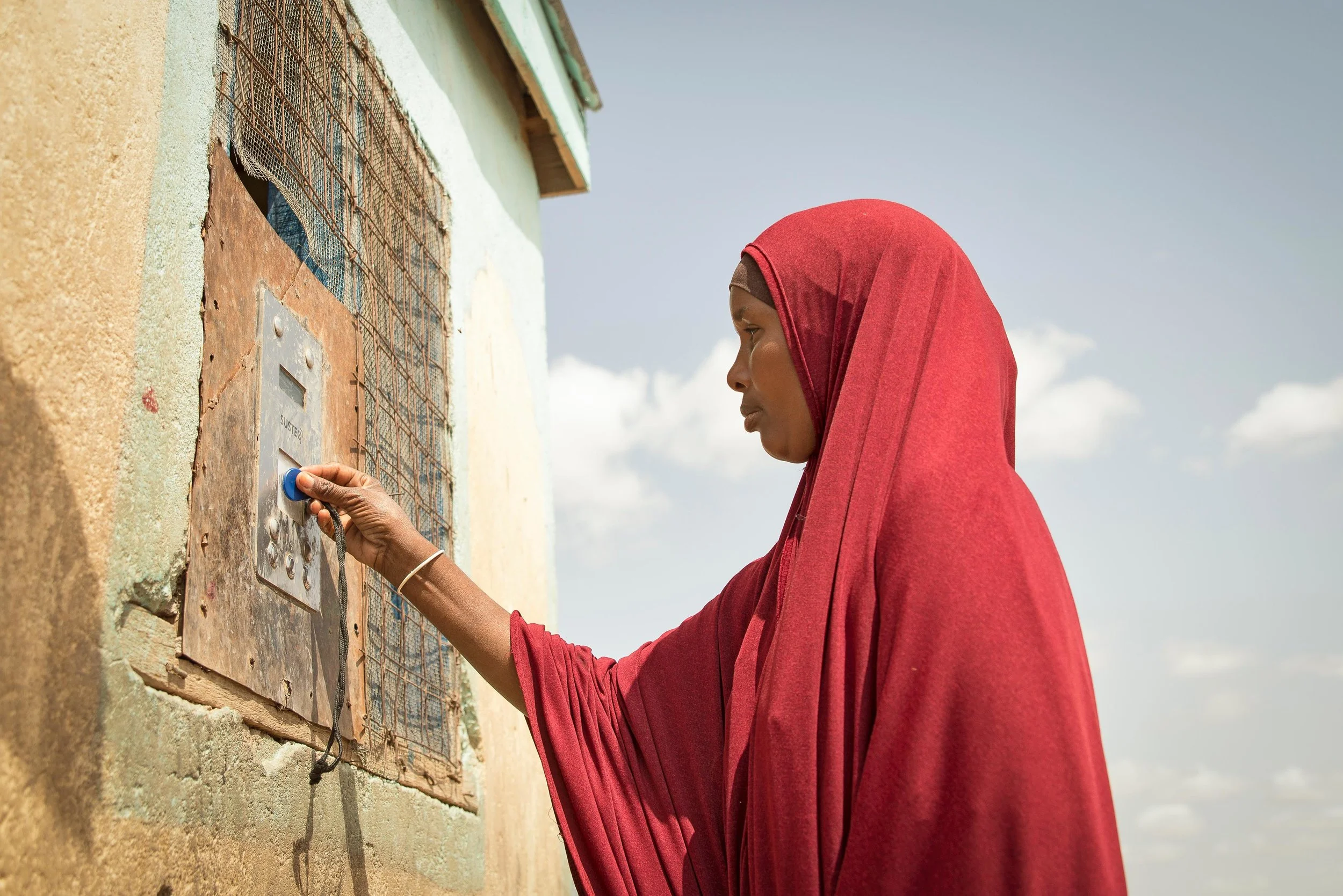 Arron Gesar, 34, holds her token to collect water from a Water ATM in Hadado, Kenya.