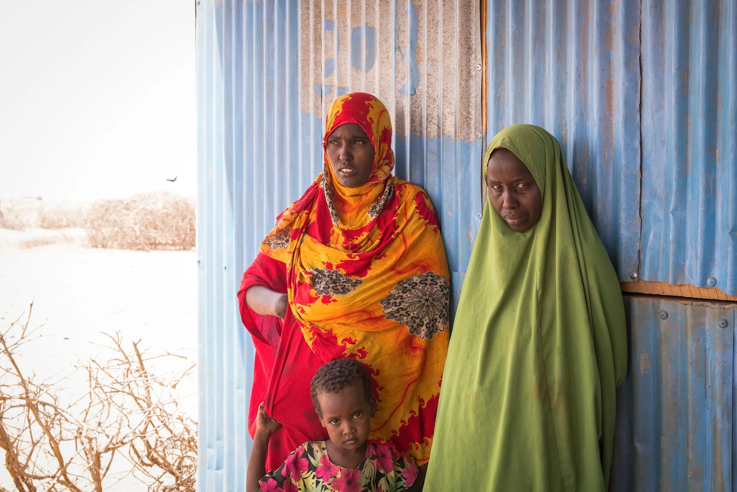 Zeinab Issack, 34, and Fatima Dakane Bulle, 38, wait for a sandstorm to pass in a remote village near Hadado Town, Northern Kenya.