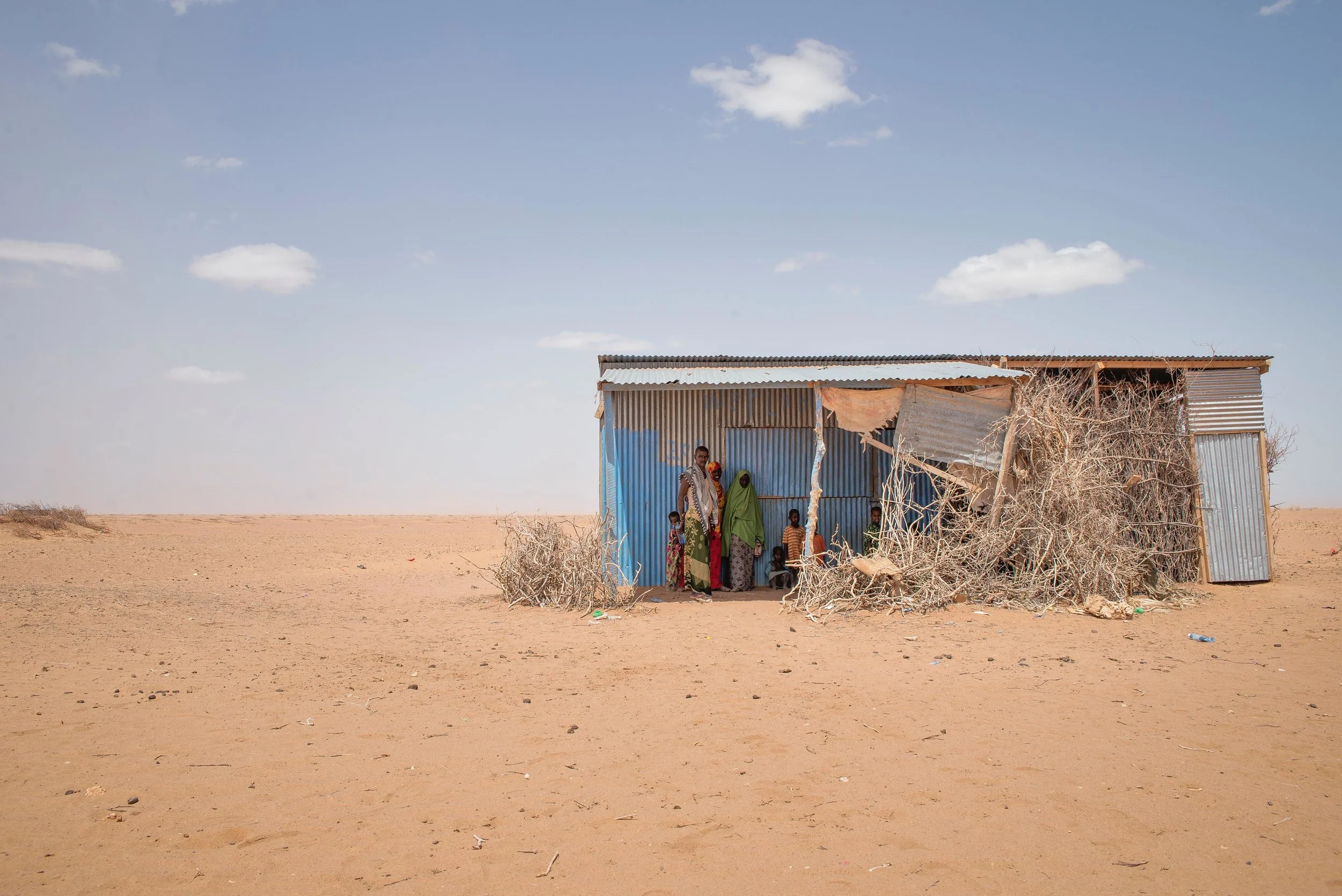 A family waits for a sandstorm to pass in an isolated village near Hadado Town in Wajir County, Kenya. "The livestock is weak now," said Gigsy Dakane, 47. "I have no means to move. I'll just stay here and wait for the rains."