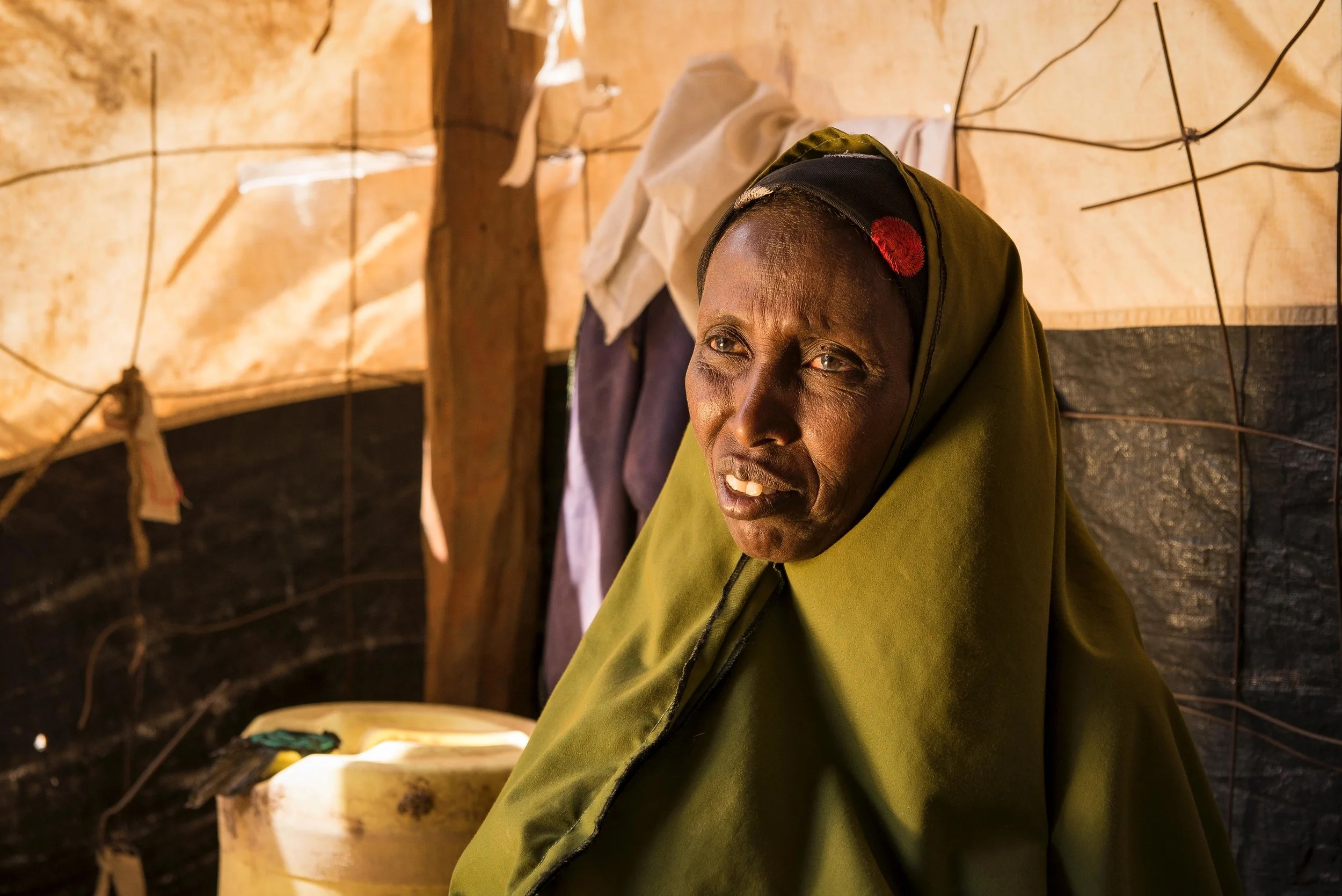 Haretha Muhaumud, 47, sits in her home in Hadado Town, Northern Kenya. Oxfam's water ATMs provide access to reliable and affordable clean water in towns across northern Kenya, a commodity that is increasingly difficult to find due to the ongoing drought in the region. The Water ATM’s "have really transformed my life," said Muhaumud. "Now, the water is very much close and it has helped me very much."