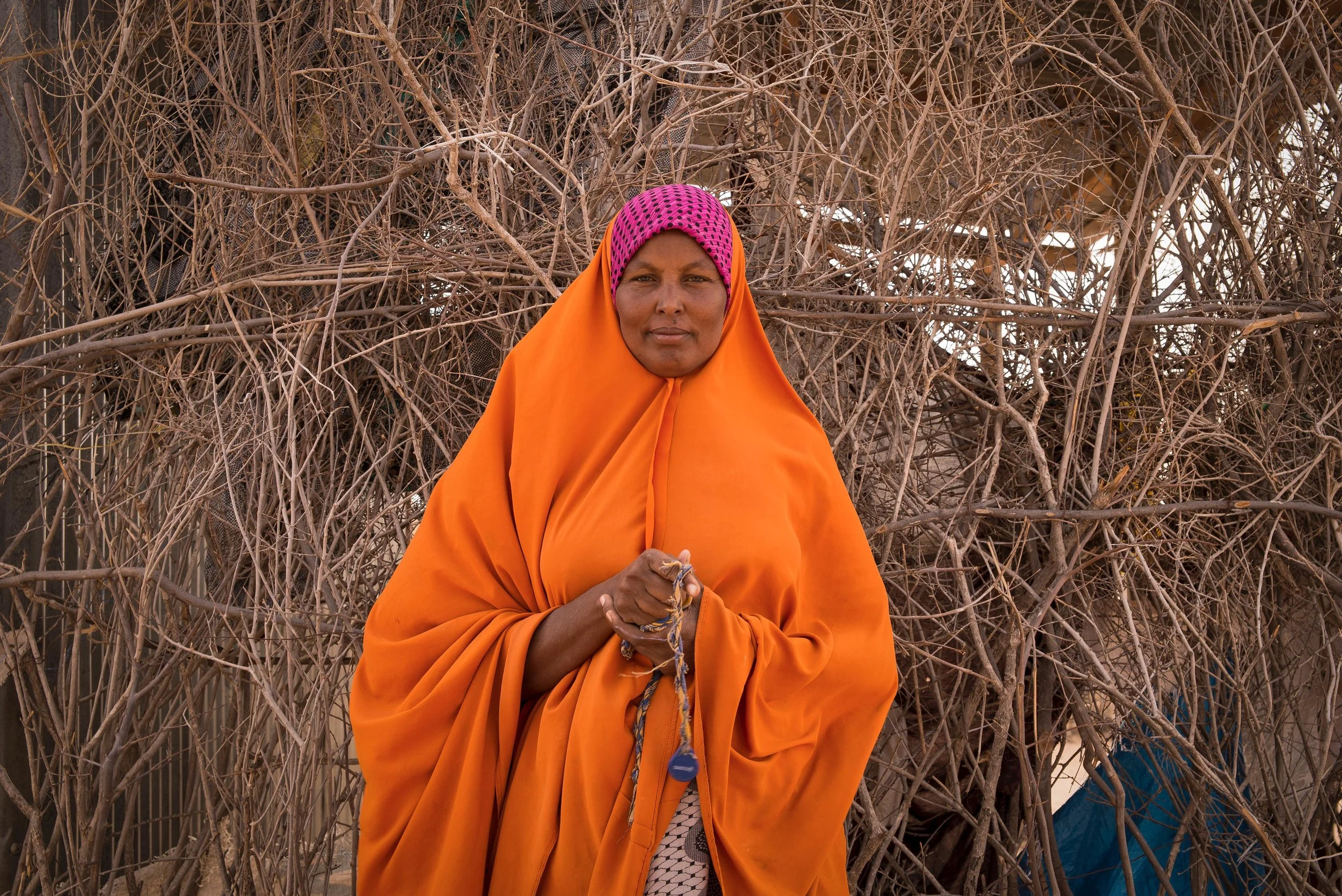 Ibadha Malele, 38, holds a Water ATM token in Hadado town, Northern Kenya.