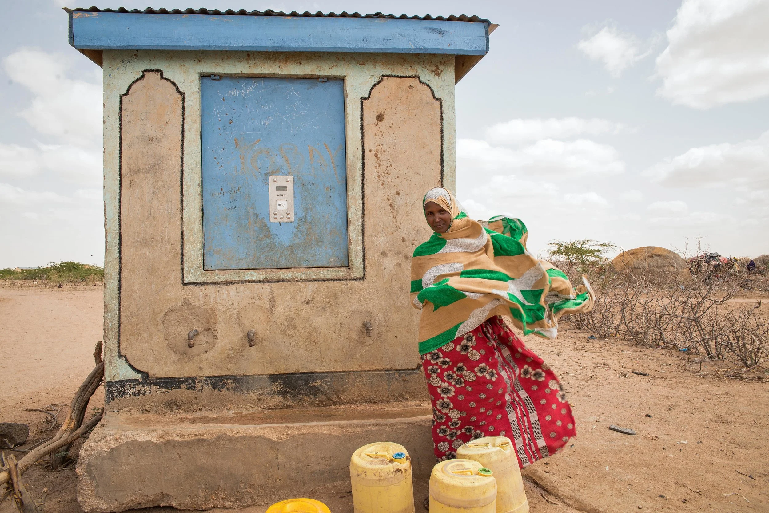 Rukia Billow, 24, collects water several times a day from a kiosk in Hadado Town, Northern Kenya. The kiosk, which distributes 20 liters of clean water for about .20 cents, provides a lifeline for many families during the ongoing drought in the region. But this water is still too costly for many mothers, whose sole source of income is the livestock that left with their husbands months before.