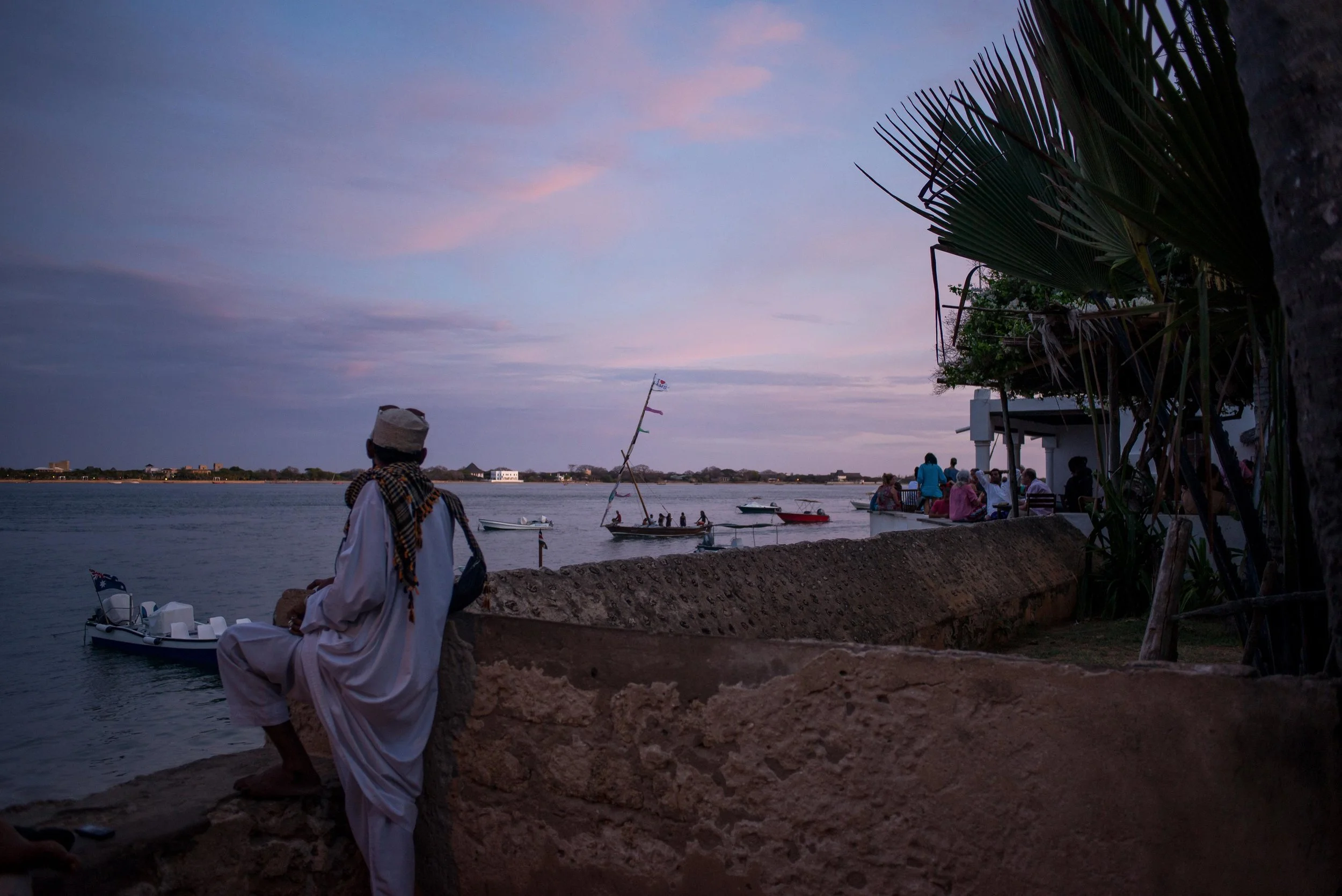 A man watches the sunset in Lamu, Kenya. March 2018.