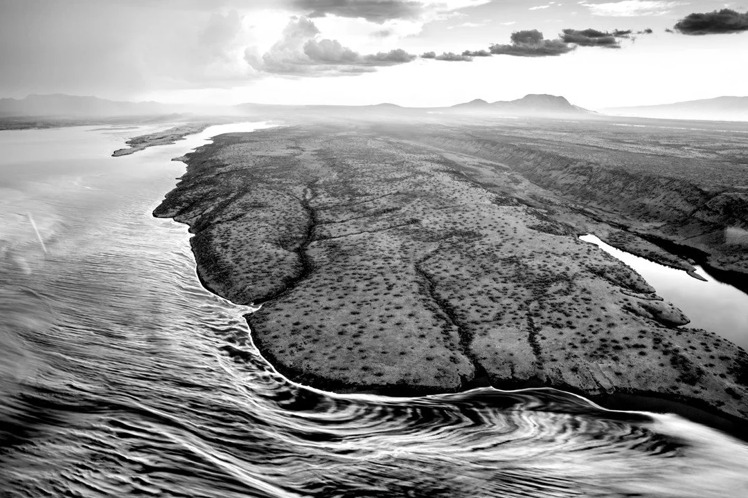 In the south of Kenya's Rift Valley lies an alkaline soda lake that is as picturesque as it is inhospitable. Yet, even here in these hot saline waters, life thrives. Flamingoes filter feed in the shallows, while tilapia specially adapted to the condi