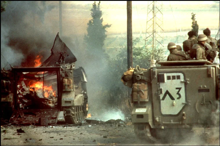 © Micha Bar Am/Magnum Photos: A column of Israeli armored personnel carriers runs into a PLO ambush east of Sidon, Lebanon (1982)
