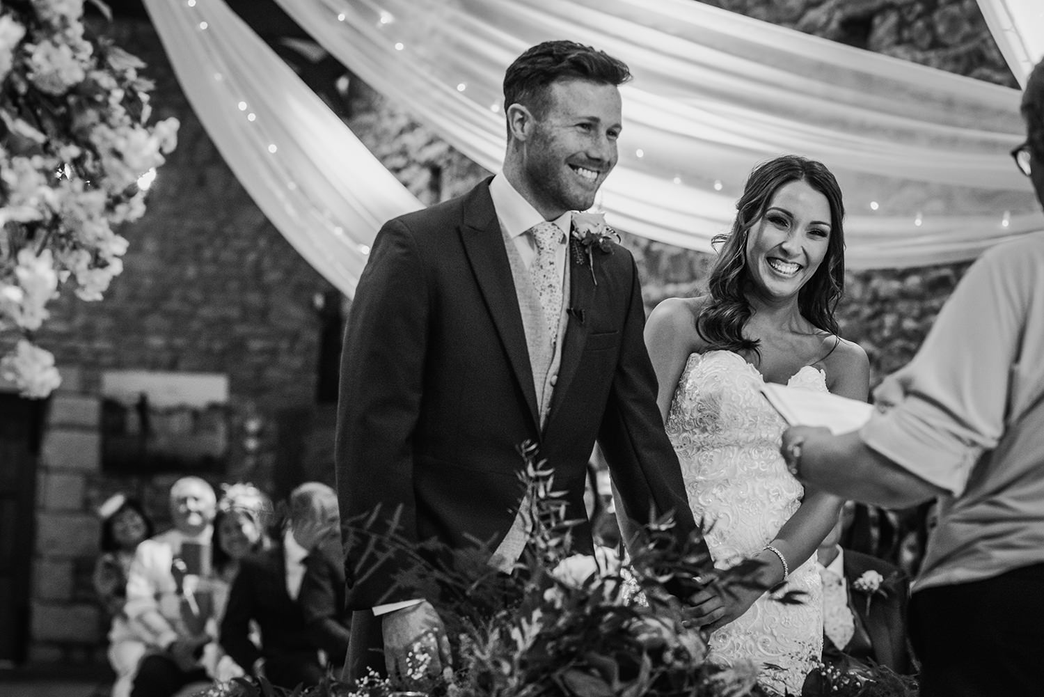 black and white image, couple happy at alter