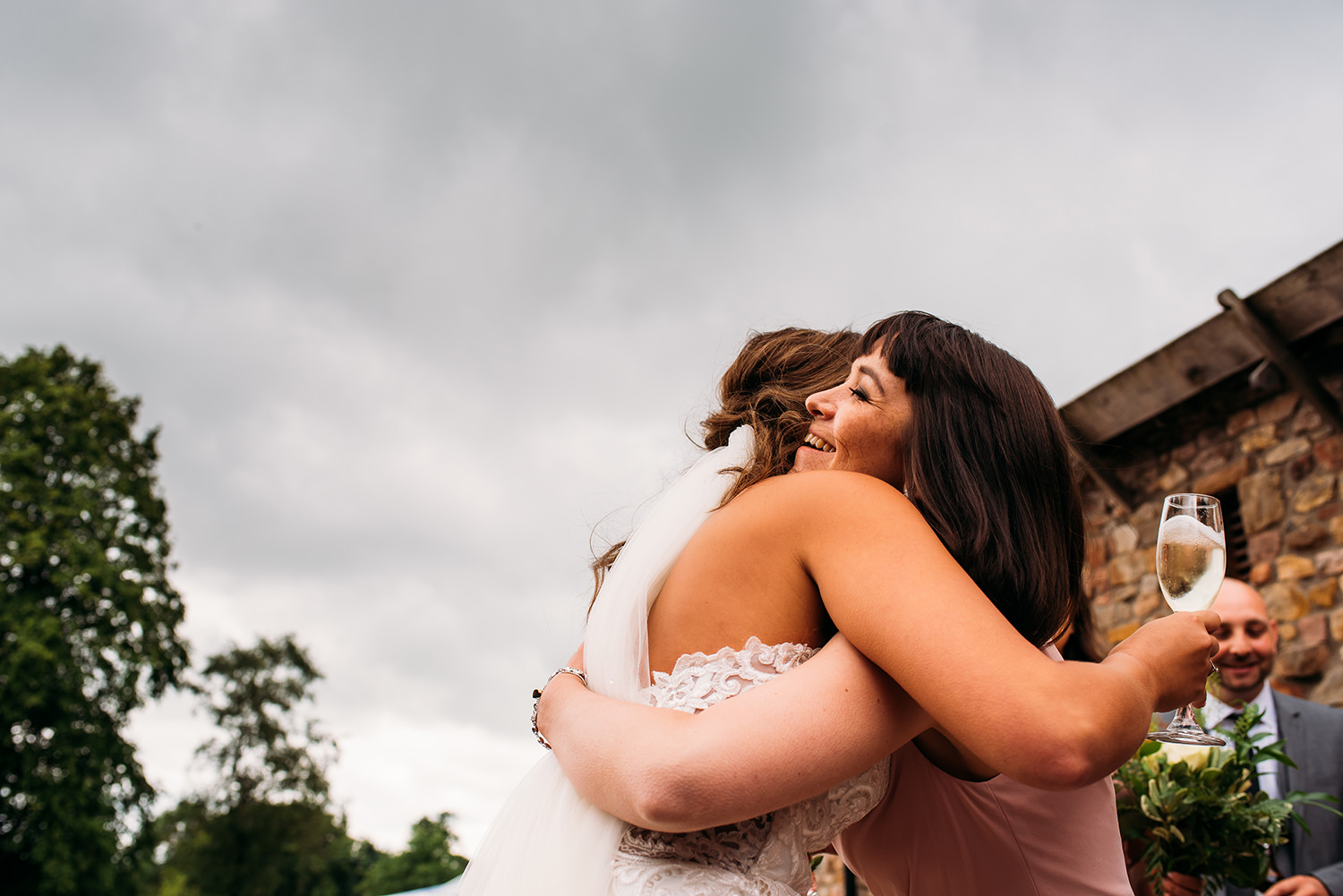  colour photo, bride hugging friend 