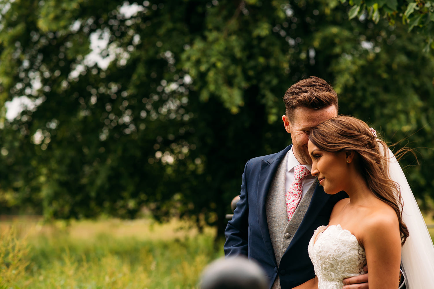  colour photo, bride and groom in field 