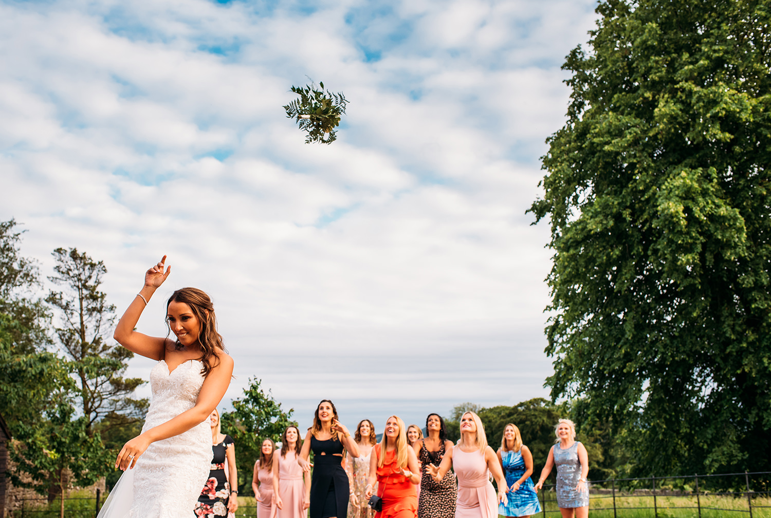  colour photo, bride throwing bouquet 