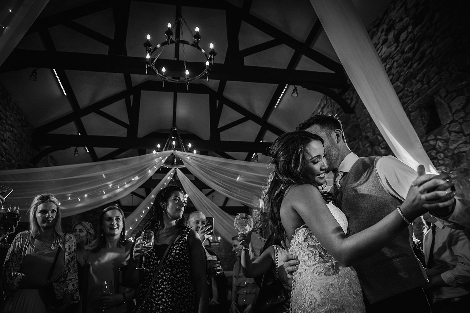  black white photo bride and groom dancing 